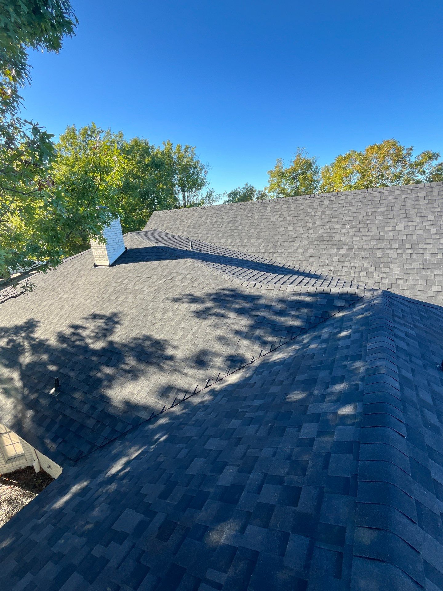 White brick with IKO Granite Black by Tejas Roofworks + Restoration
