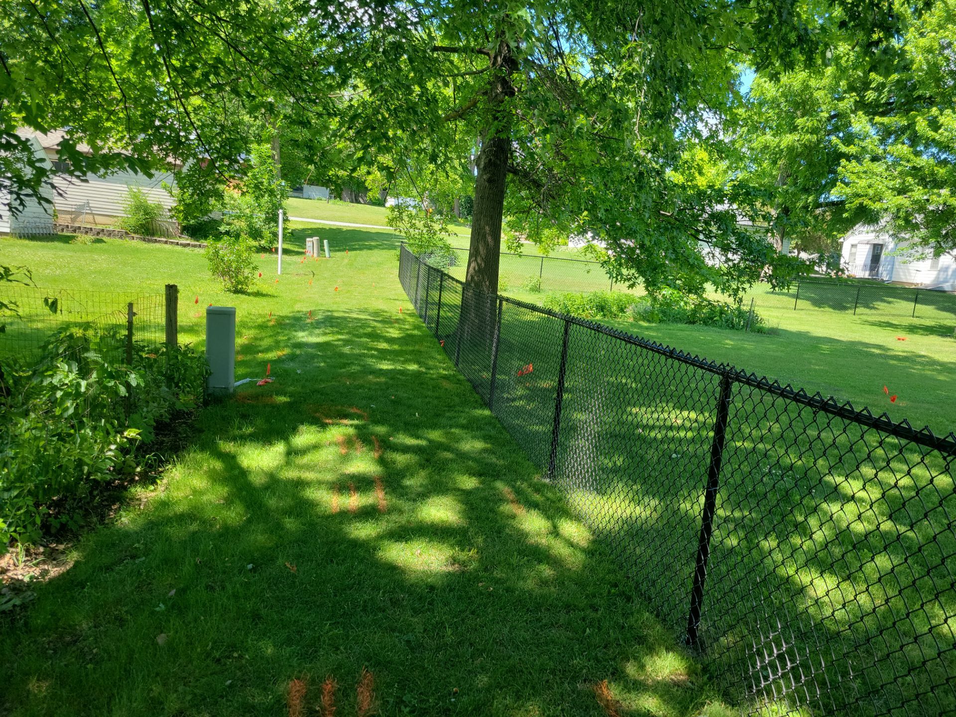 Black Chain Link Perimeter Fence and Driveway Gate in Waverly by Perfect Picket Fence and Stain
