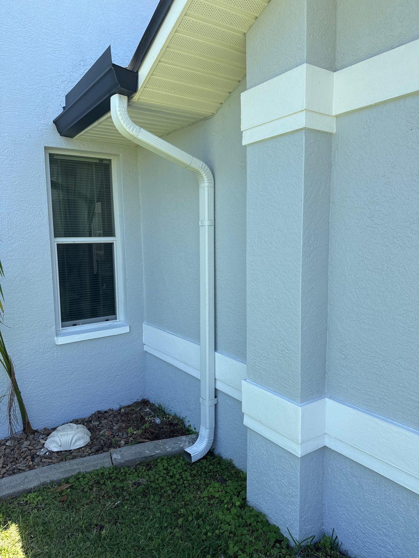 Black Seamless Gutters and White Downspouts in Cape Coral FL by Gutter Professors