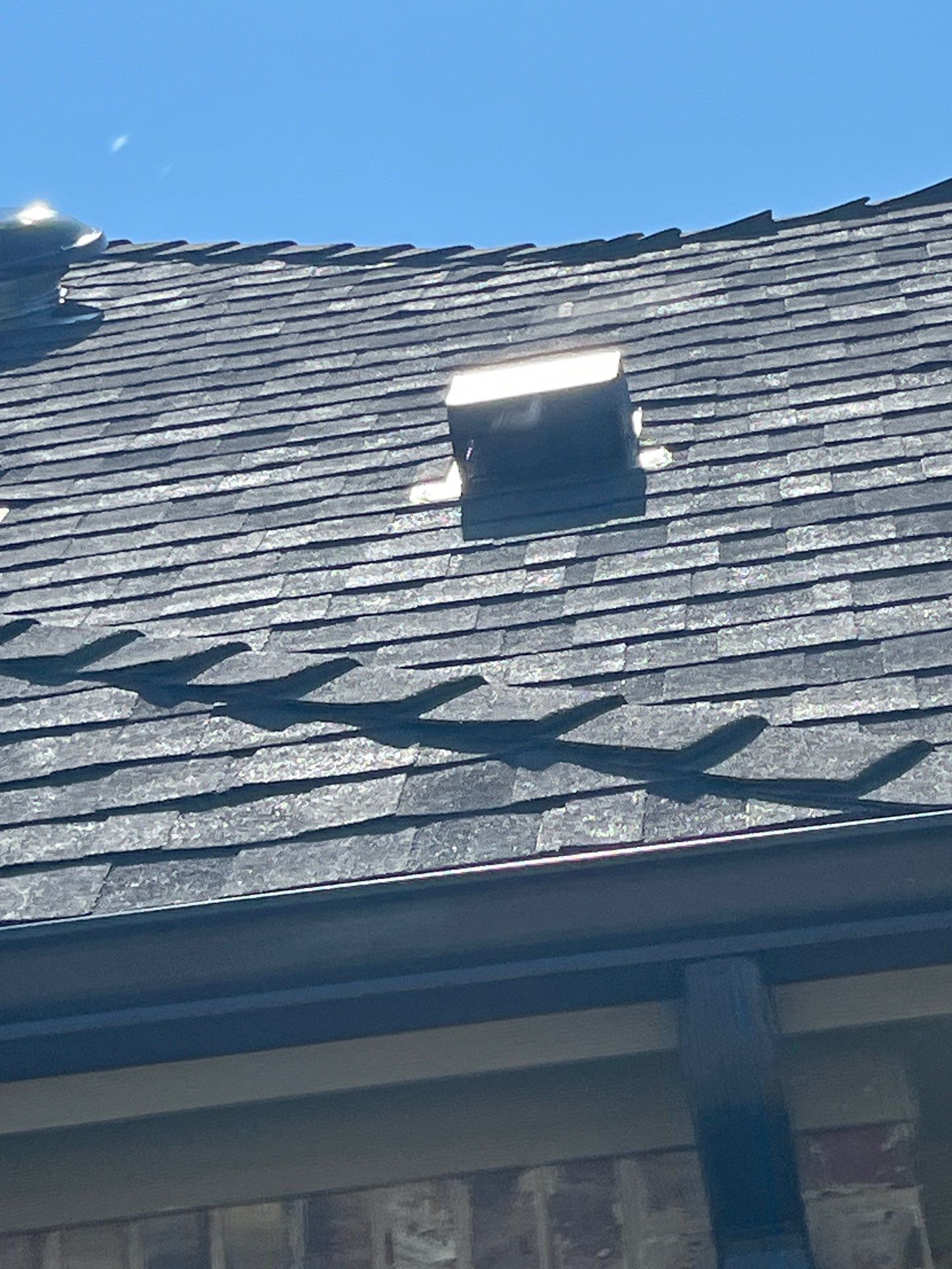 IKO Granite Black-Light Brown with dark brown sections brick house  by Tejas Roofworks + Restoration