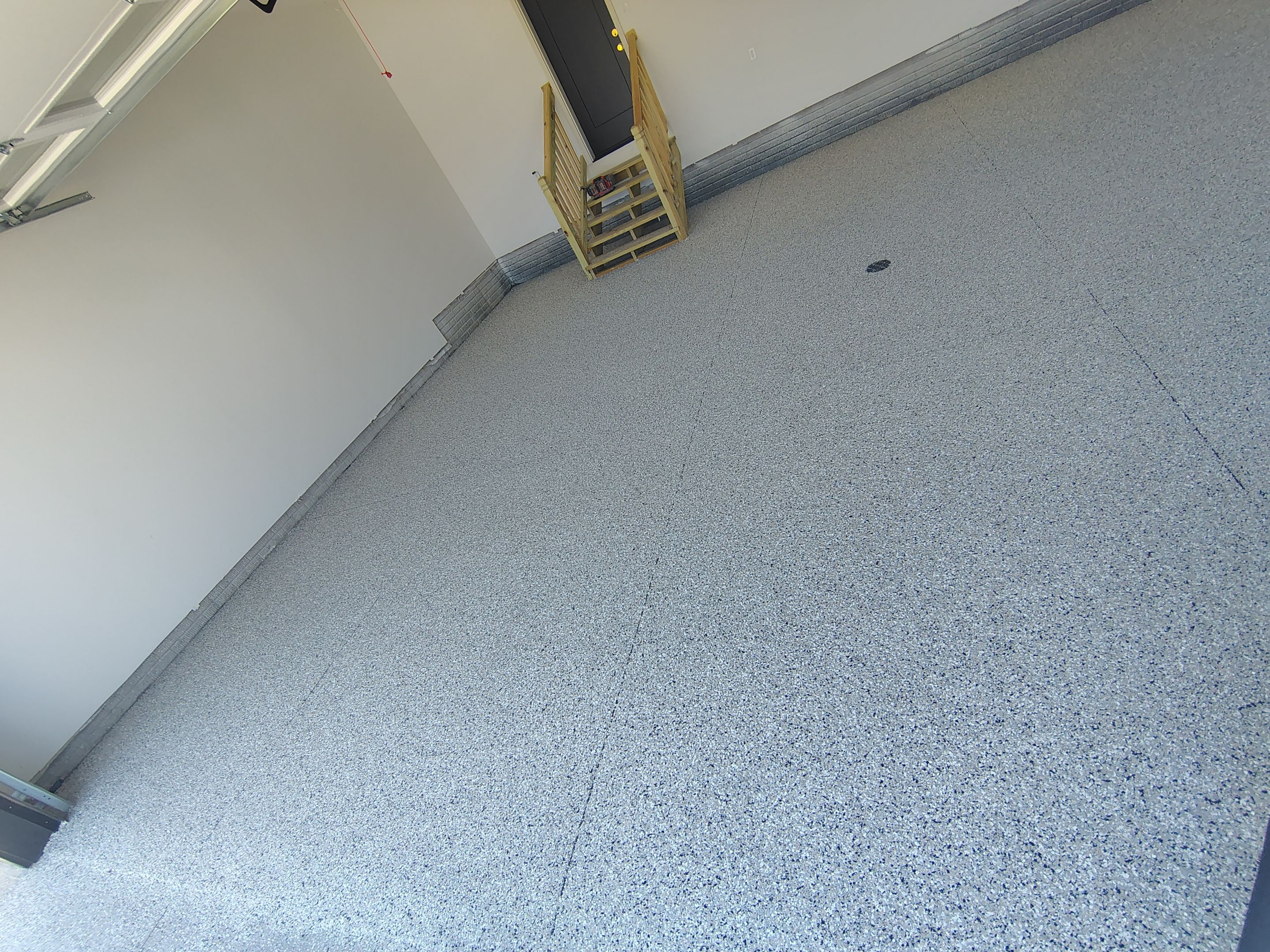 Cabin Fever Decorative Flake Garage Floor Coating in Sioux Falls by Select Painting, Coatings & Garage Cabinets