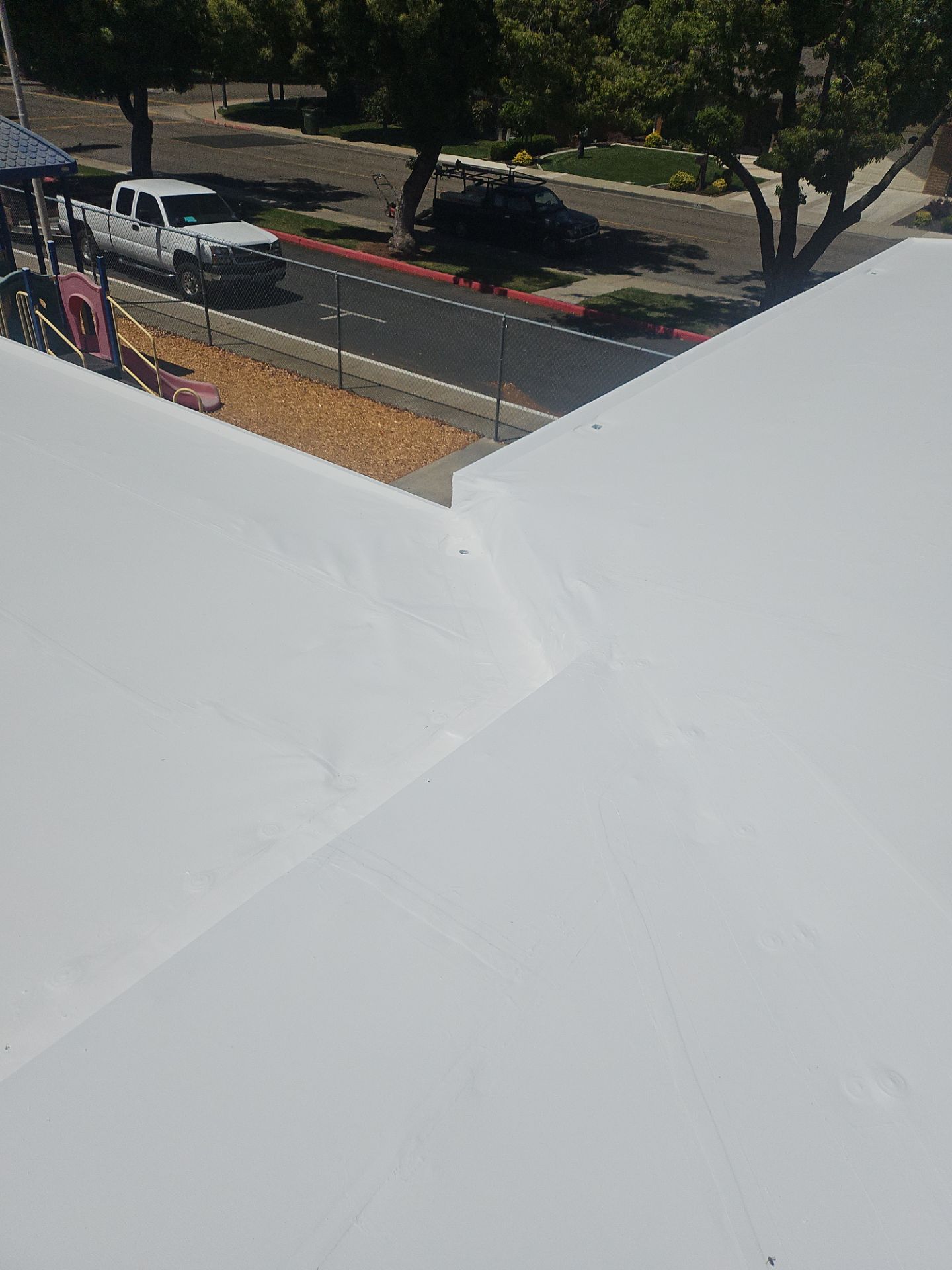 Single-ply restoration system using Benchmark/PUMA XL coatings over TPO single-ply roofing by Straight Edge Roofing Inc