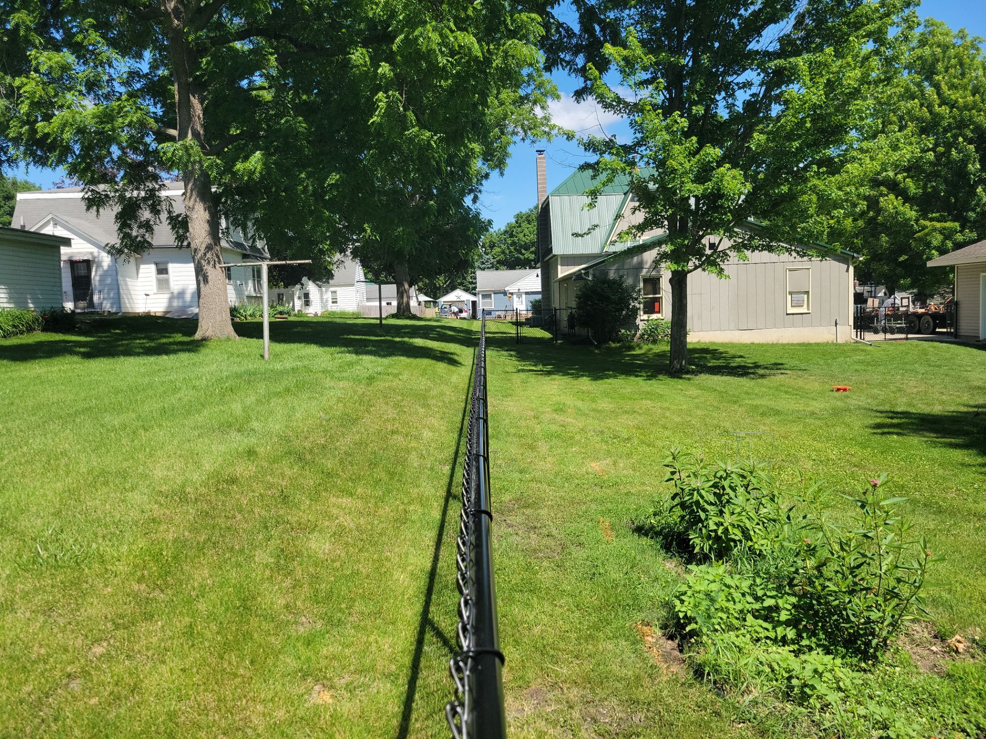 Black Chain Link Perimeter Fence and Driveway Gate in Waverly by Perfect Picket Fence and Stain