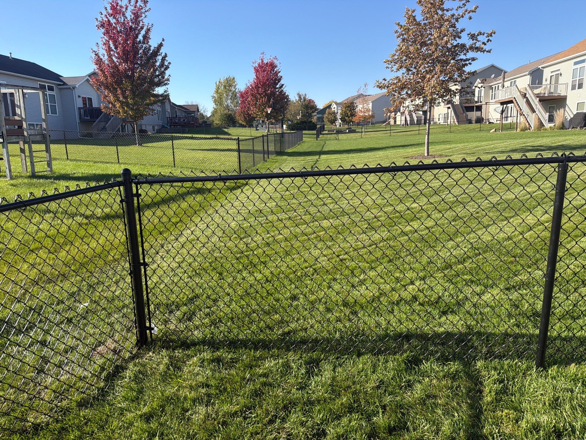 Black Vinyl-Coated Chain Link Fence Installation in Cedar Falls by Perfect Picket Fence and Stain