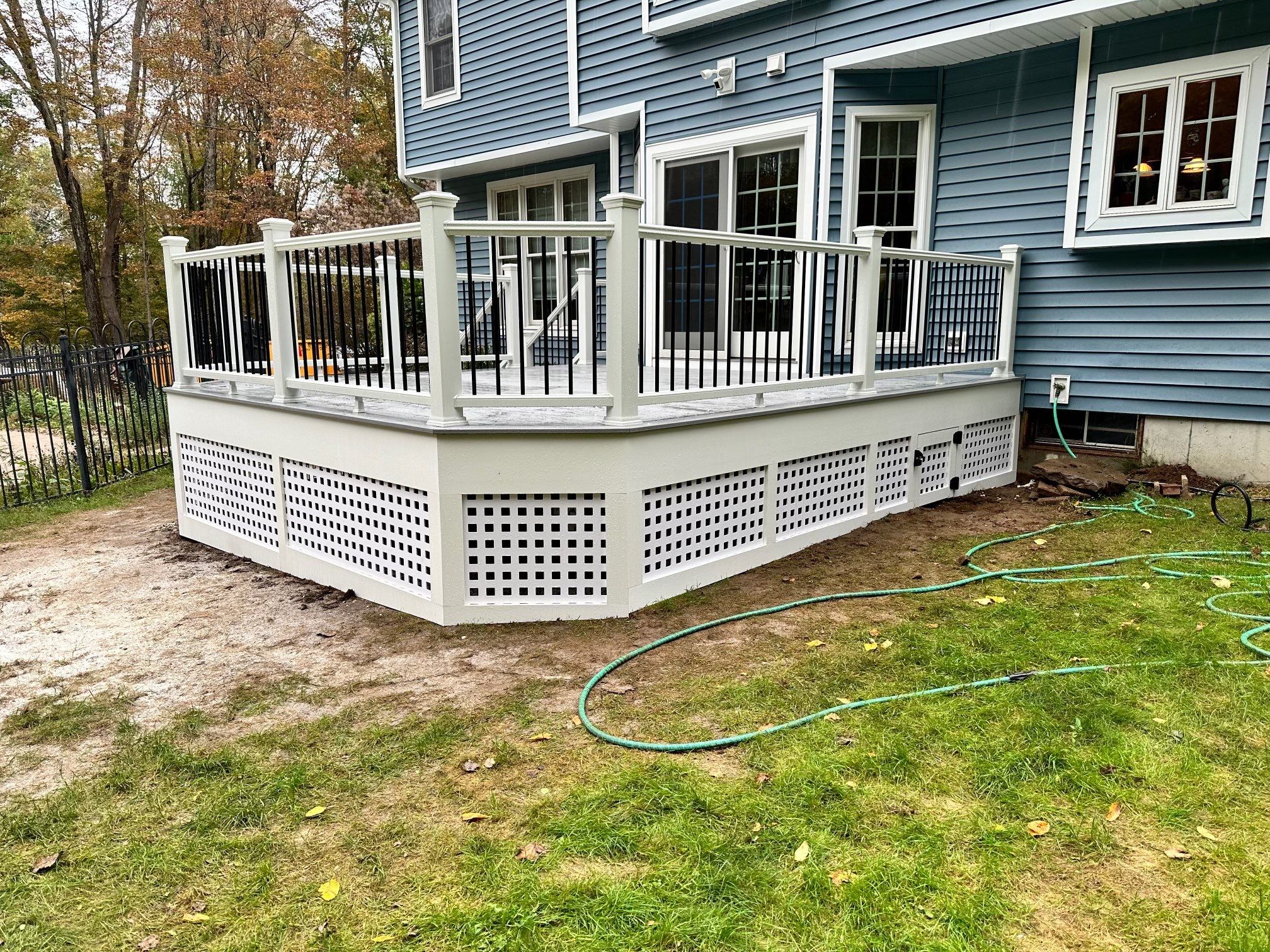 Deck replacement using Trex lineage Rainier with angled edges, Transcend cocktail rail and lattice. by DiGiorgi Roofing and Siding Inc