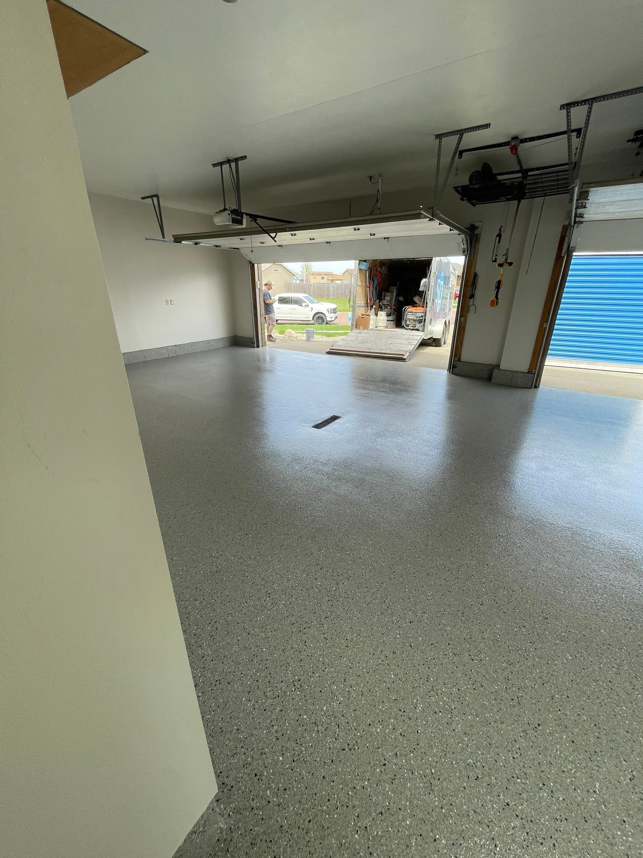 Residential Garage Floor Coating with Grey Speckled Epoxy Finish by Select Painting, Coatings & Garage Cabinets
