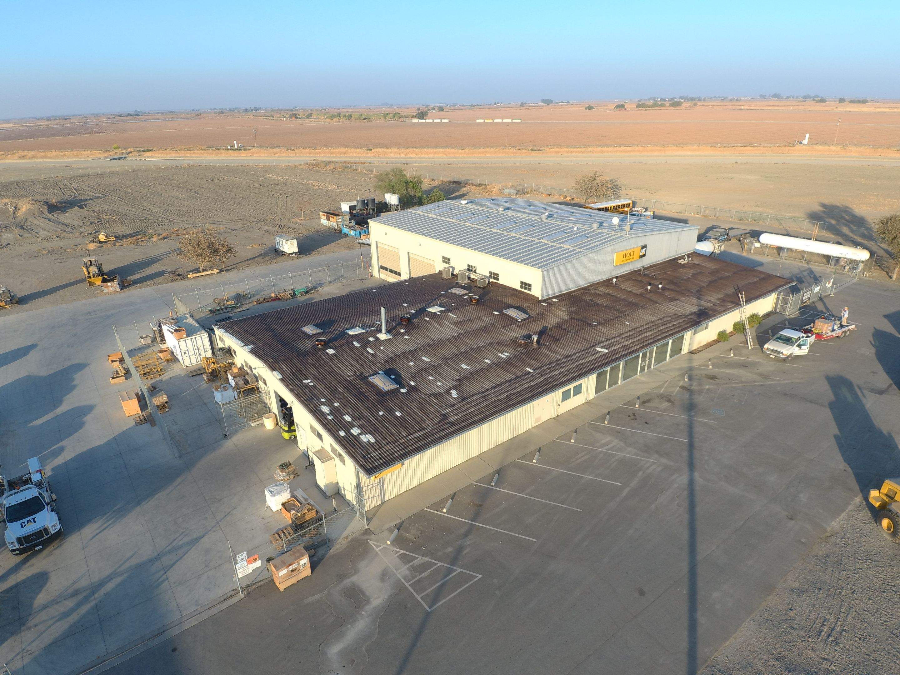 Metal roof restoration on commercial roof using Conklin Benchmark/ PUMA XL acrylic coatings over metal and foam by Straight Edge Roofing Inc