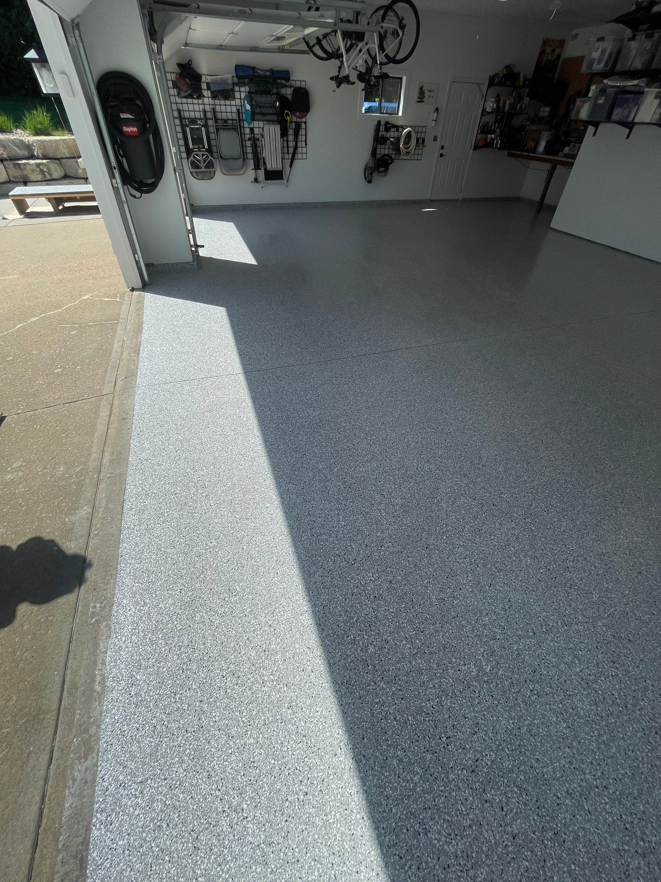 Feather Grey Garage Floor Coating Installation in Sioux Falls by Select Painting, Coatings & Garage Cabinets
