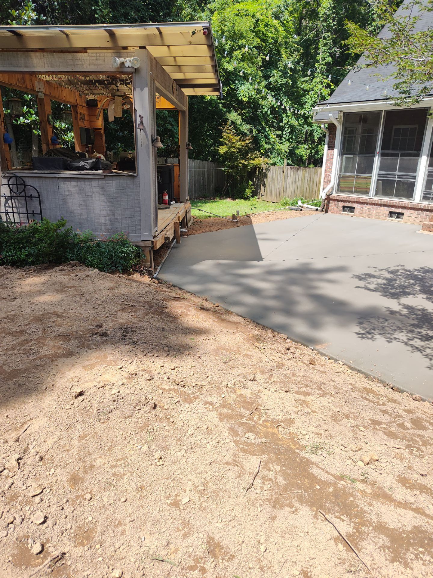 Patio in concrete with drainage improvements by Cornerstone Home Builders, LLC
