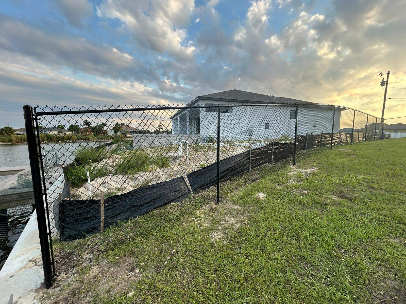Black Chain Link Perimeter Fence and Utility Enclosure in Cape Coral by True Fence LLC