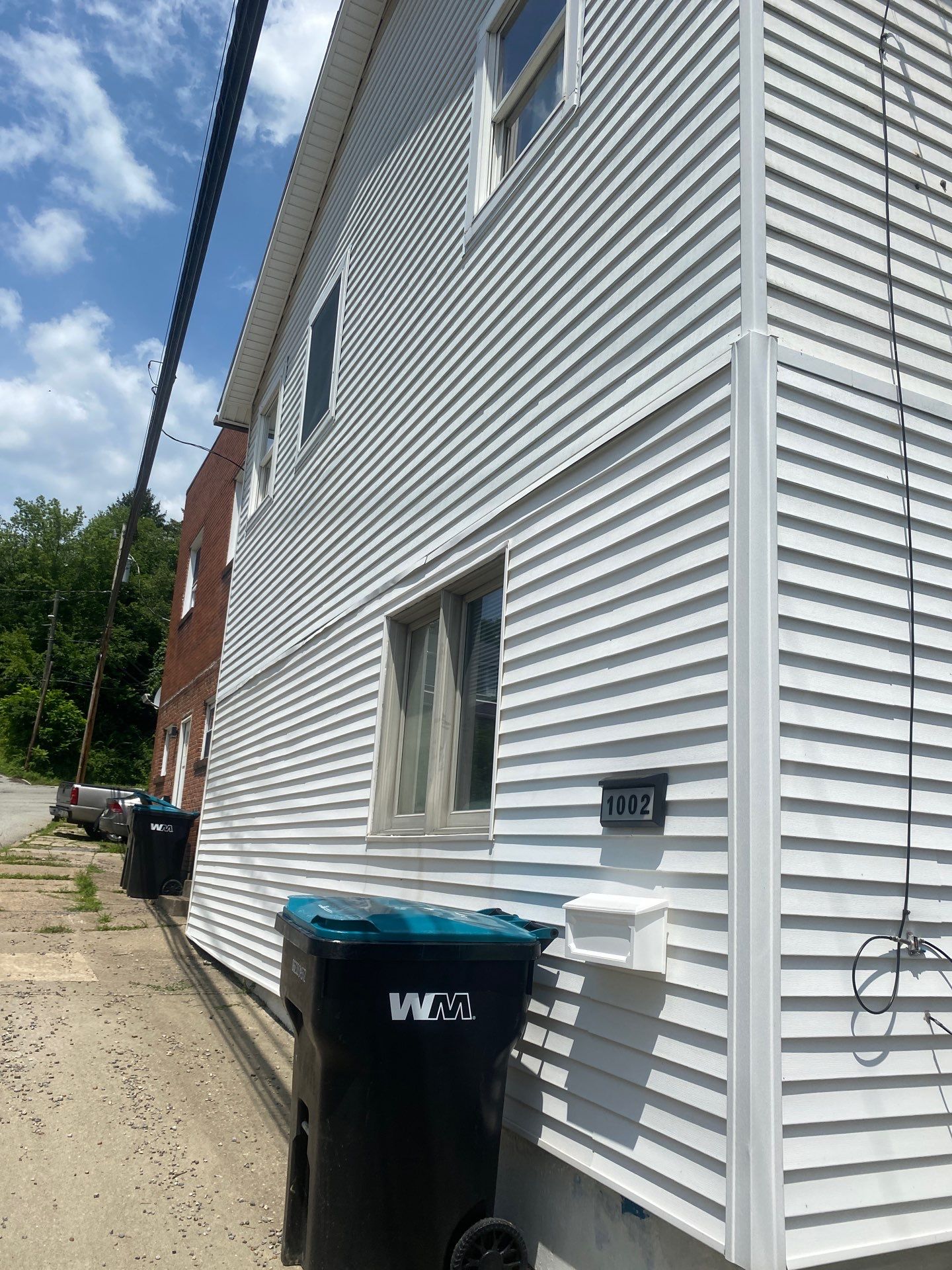 White siding  by Cousins Roofing Siding & Decks