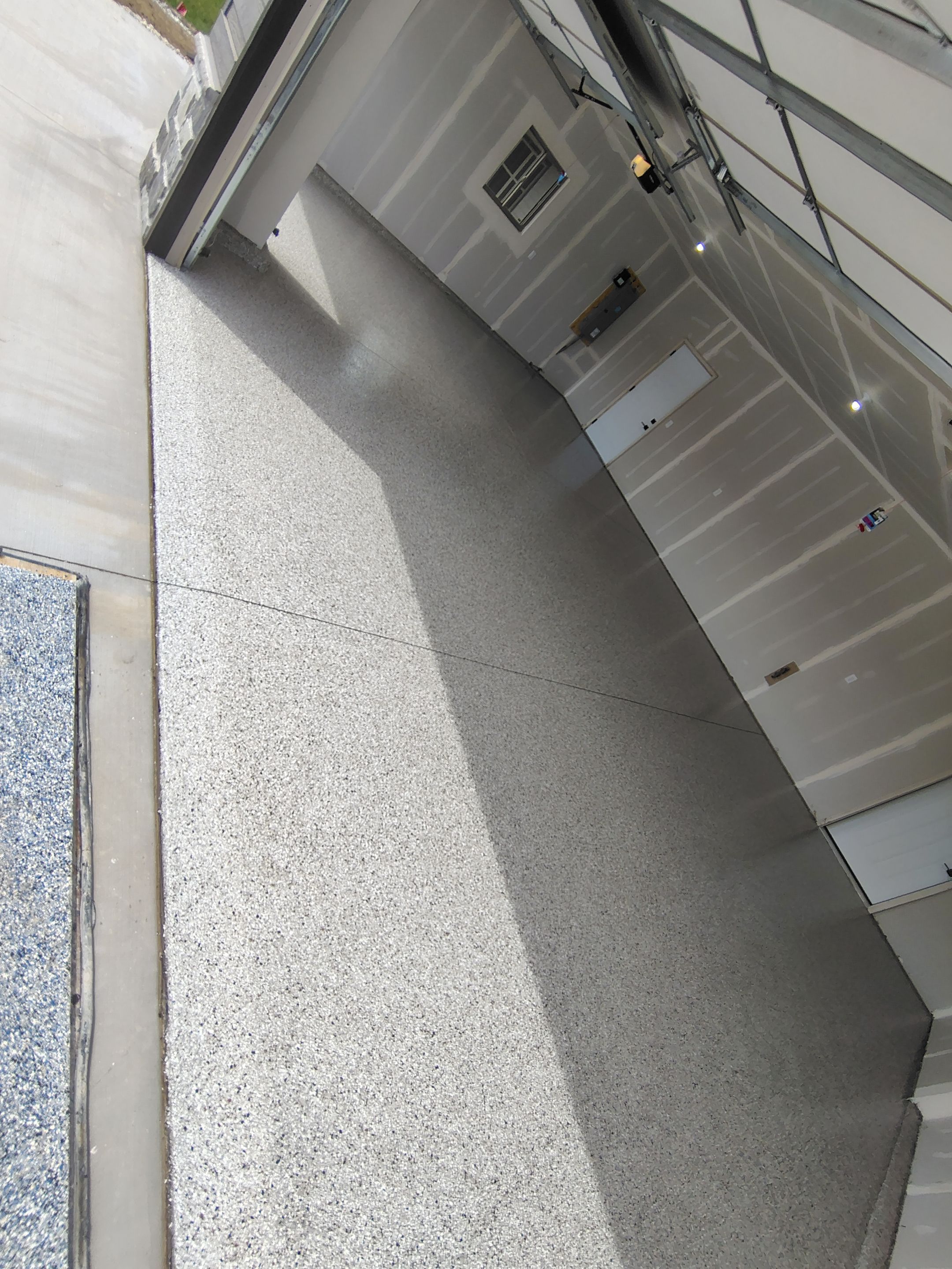 Speckled Epoxy Garage Floor Coating Installation in Sioux Falls by Select Painting, Coatings & Garage Cabinets