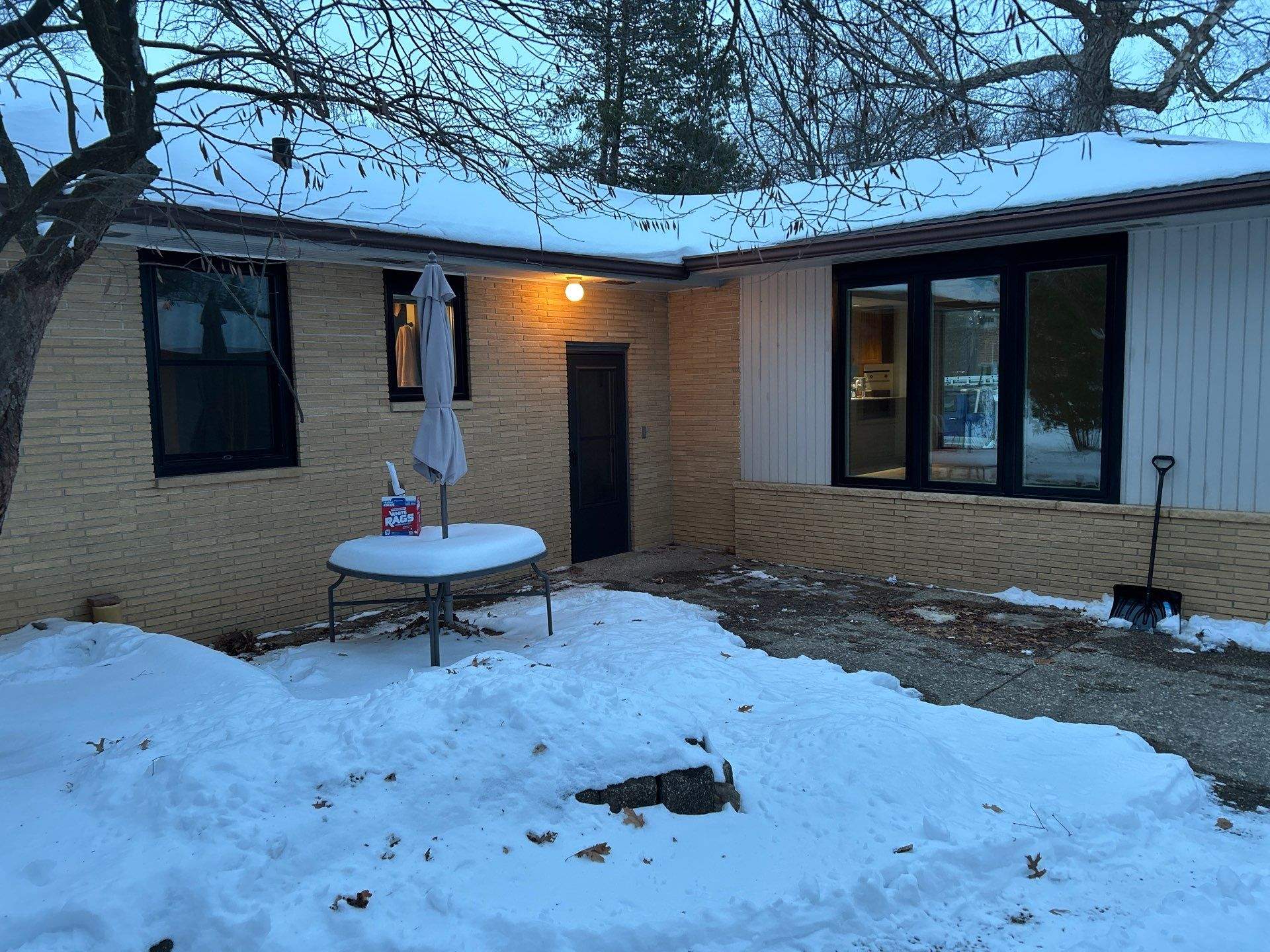 Black-Frame Pella Lifestyle Upgrade on a Partial Brick Home by United Windows and Siding LLC
