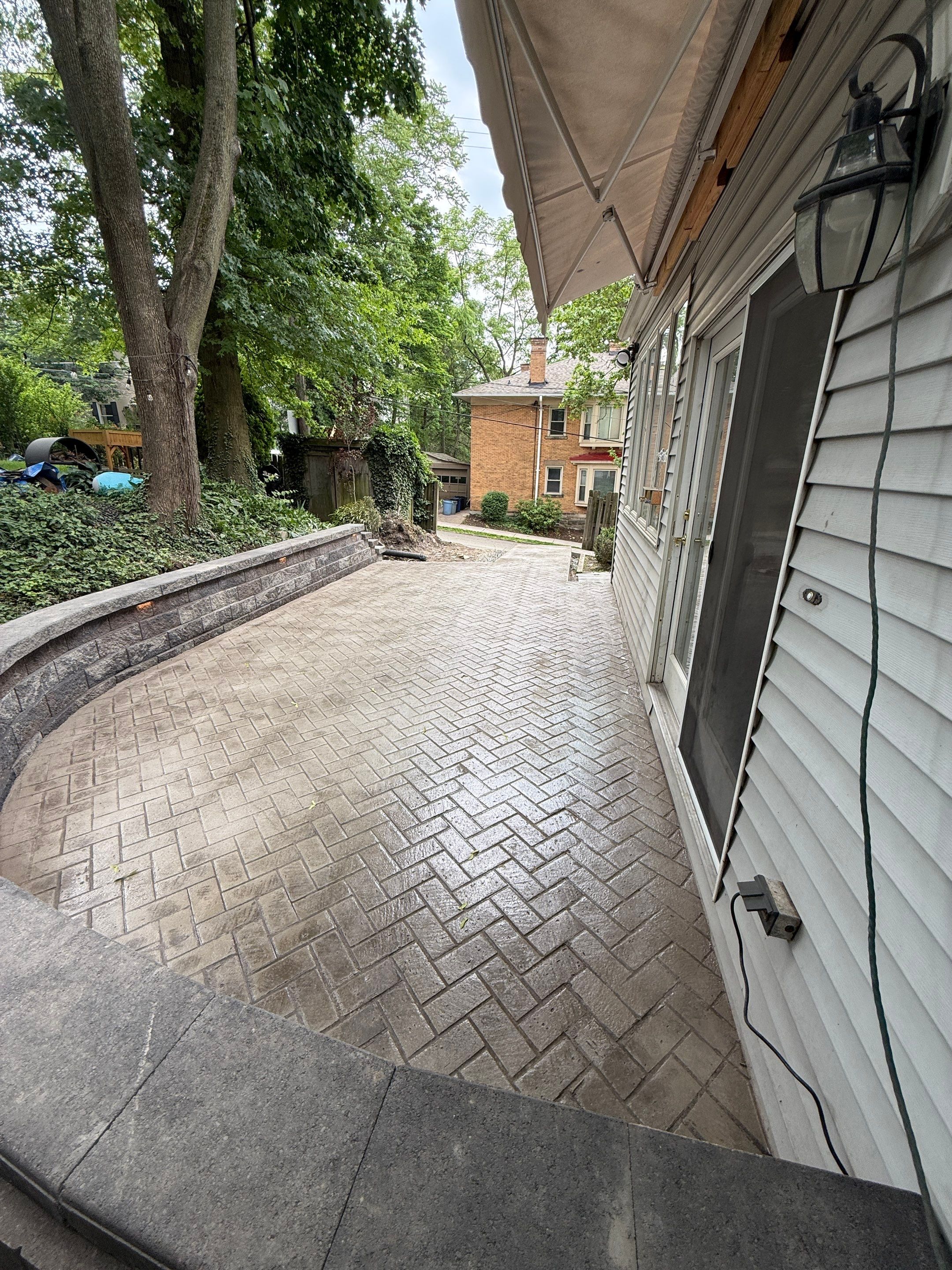 Stamped Concrete and Retaining Wall by Cousins Roofing Siding & Decks