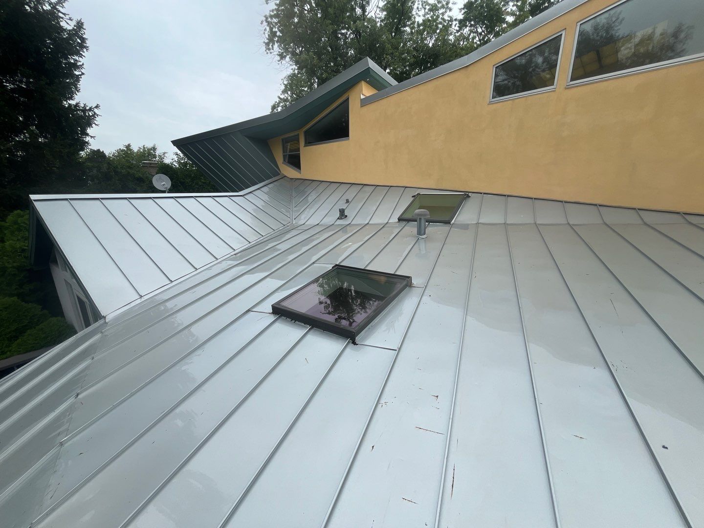 roof washing using Algaecide, soft wash soap by Northern Power Washing LLC.