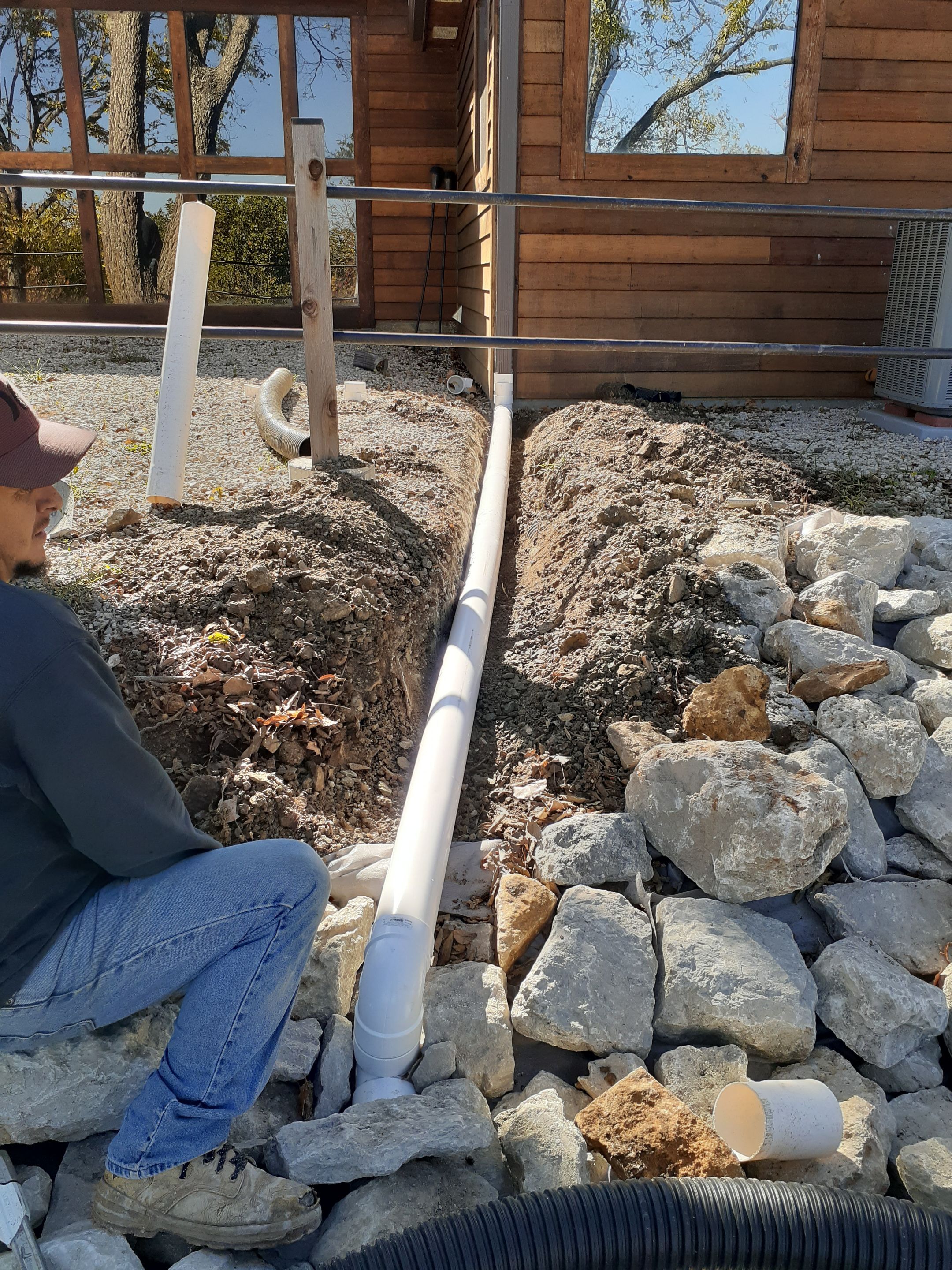 Supporting back of home with backfill at edge of steep creek by LAND ESCAPES LLC