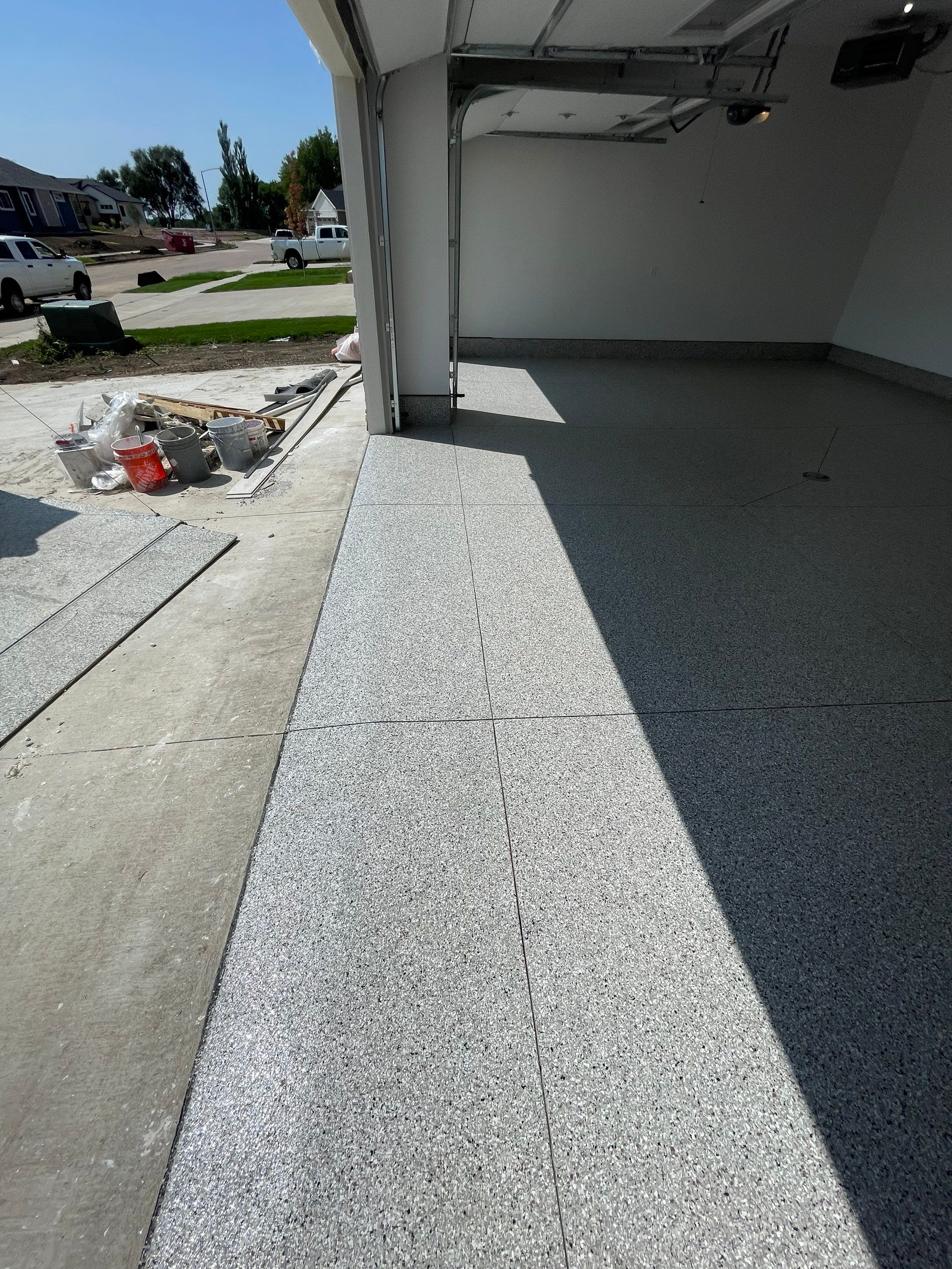 Grey Speckled Garage Floor Coating in Sioux Falls by Select Painting, Coatings & Garage Cabinets
