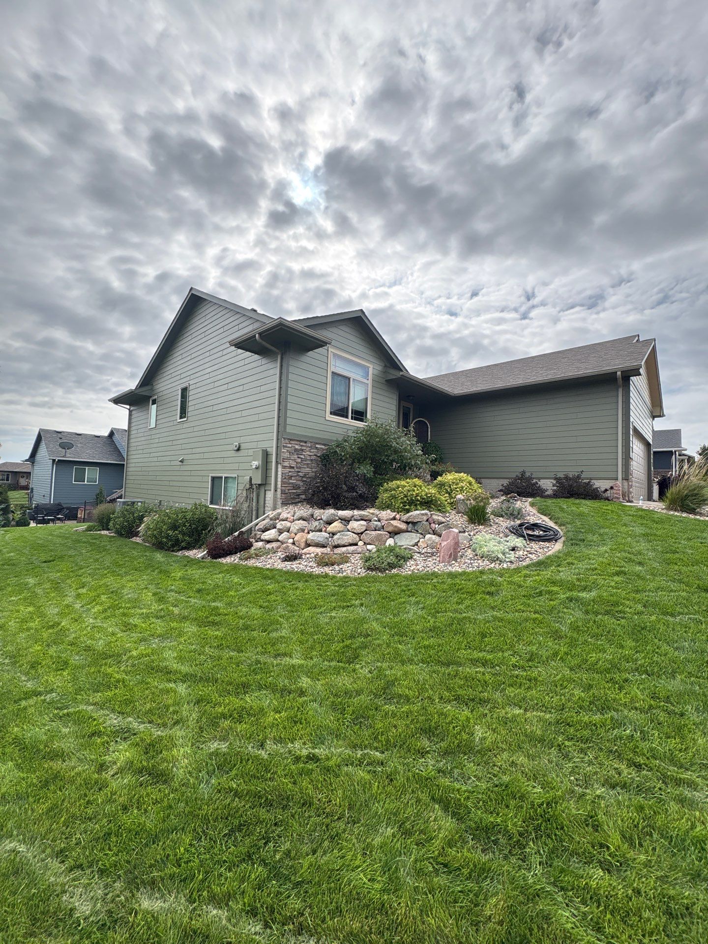Residential Exterior Painting and Siding Update in Brandon by Select Painting, Coatings & Garage Cabinets