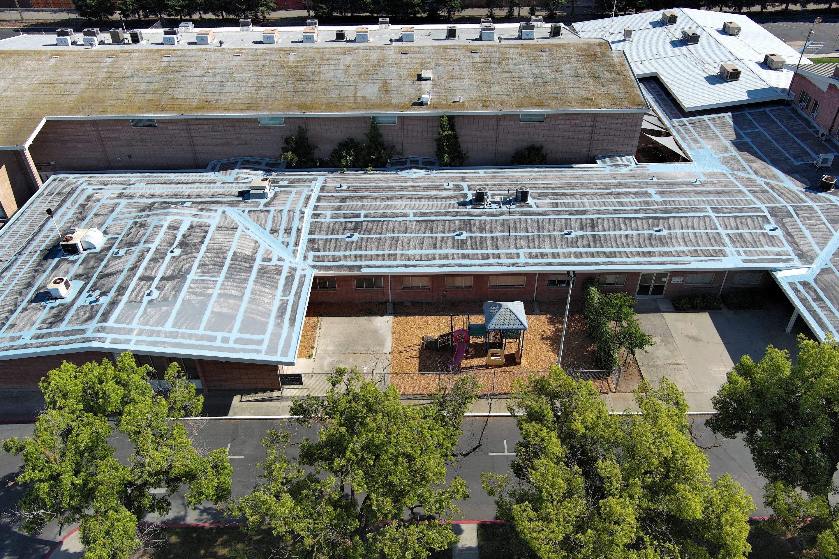 Single-ply restoration system using Benchmark/PUMA XL coatings over TPO single-ply roofing by Straight Edge Roofing Inc