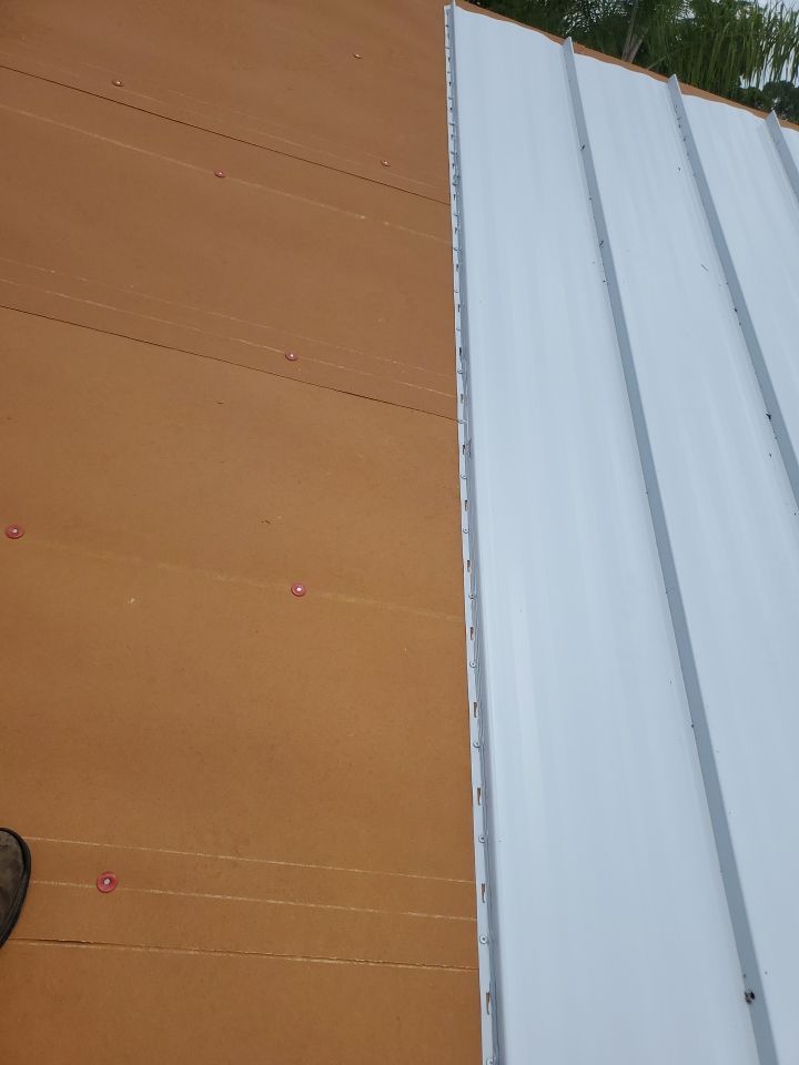 Residential Roofing Installation using 1.5" Nail Strip 24ga Solar White Kynar Coated Standing Seam Metal Panels by Morton Roofing, Inc.