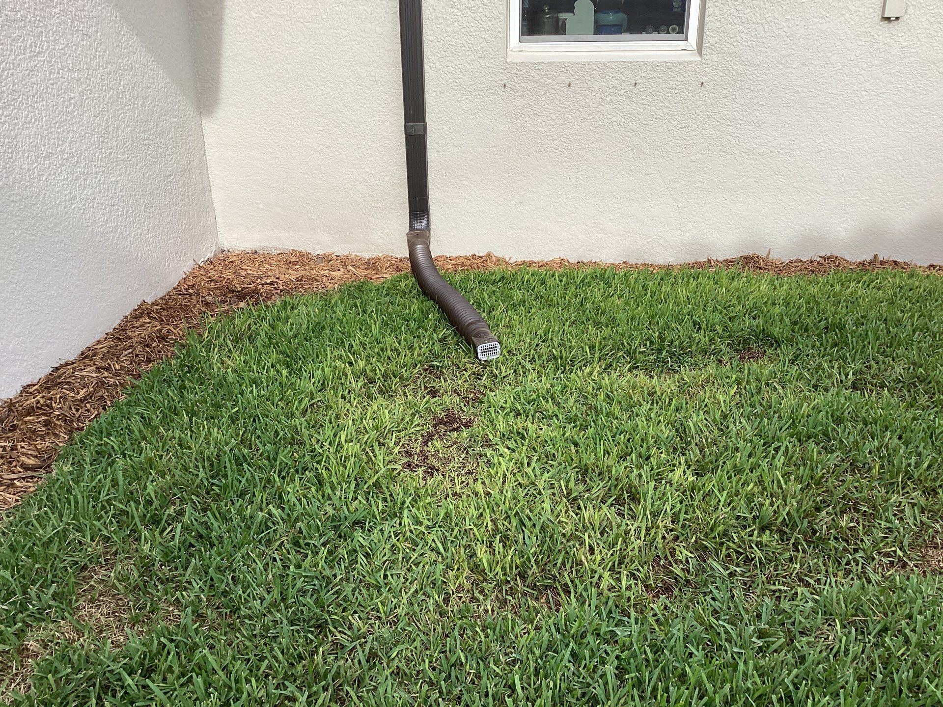 Musket brown seamless gutters with splash guards, new downspouts, and extensions in Bradenton, FL by Gutter Professors