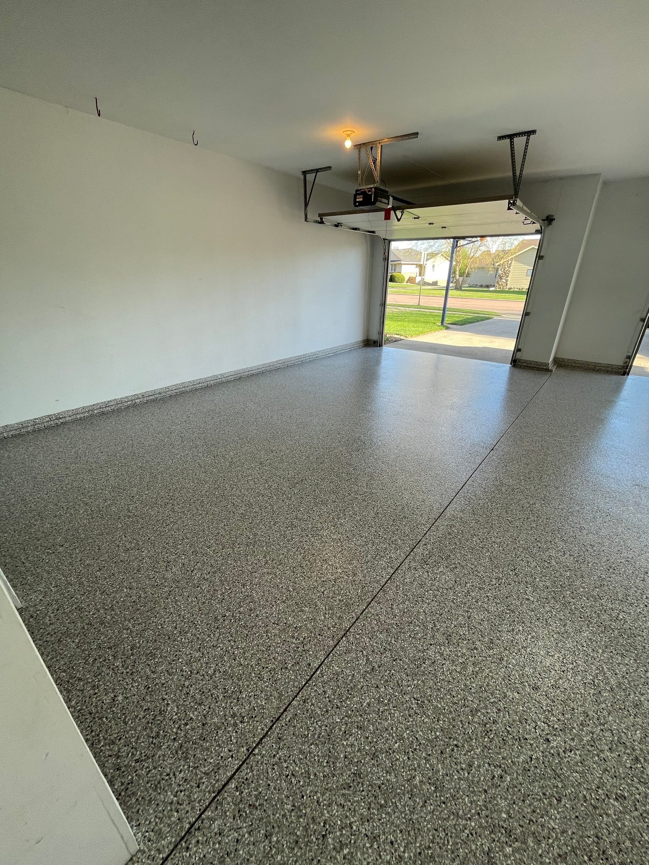 Yankton Garage Floor Restoration with Gray Speckled Epoxy Coating by Select Painting, Coatings & Garage Cabinets