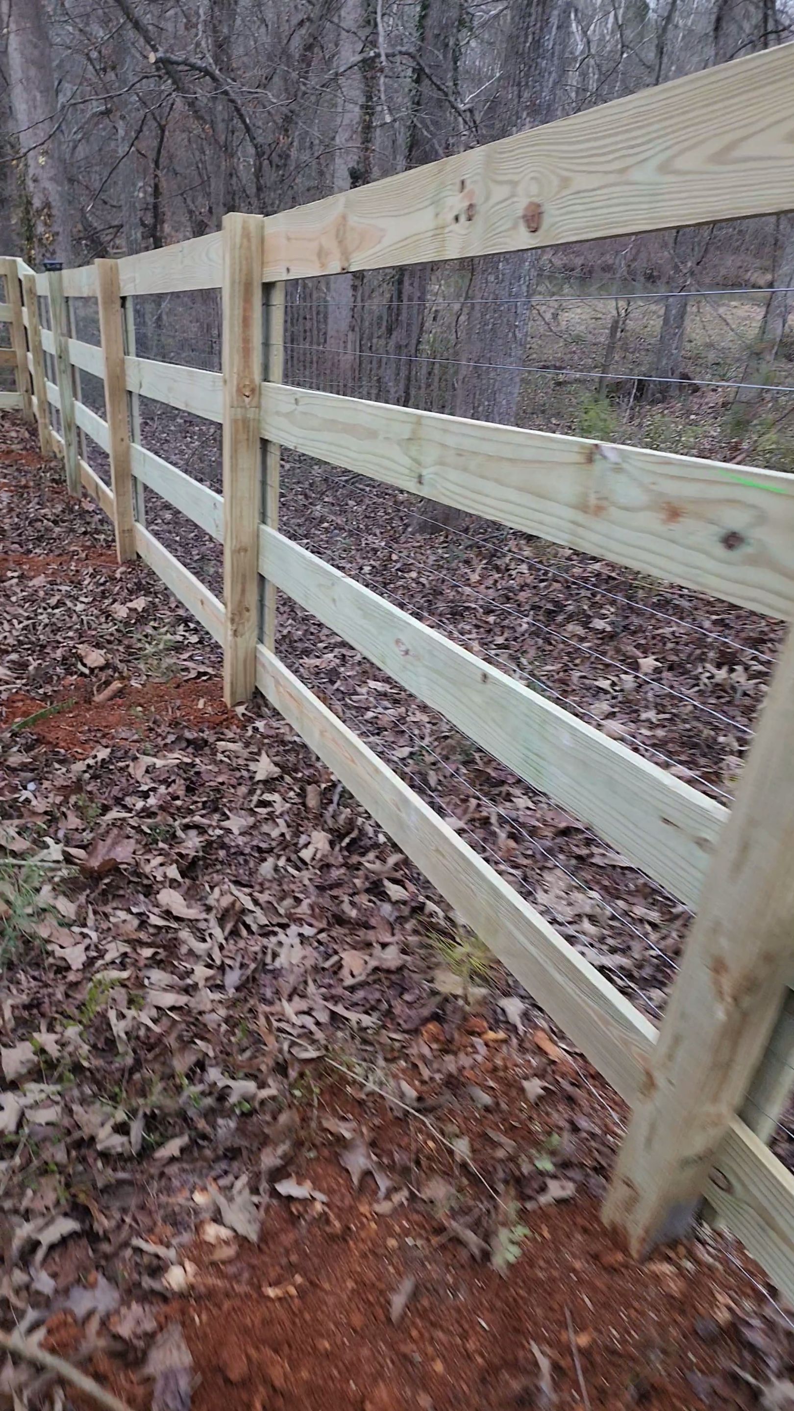 Fence Installation of 4 Rail Ranch Fence with Welded Wire by Titans of Timber Fence & Stain
