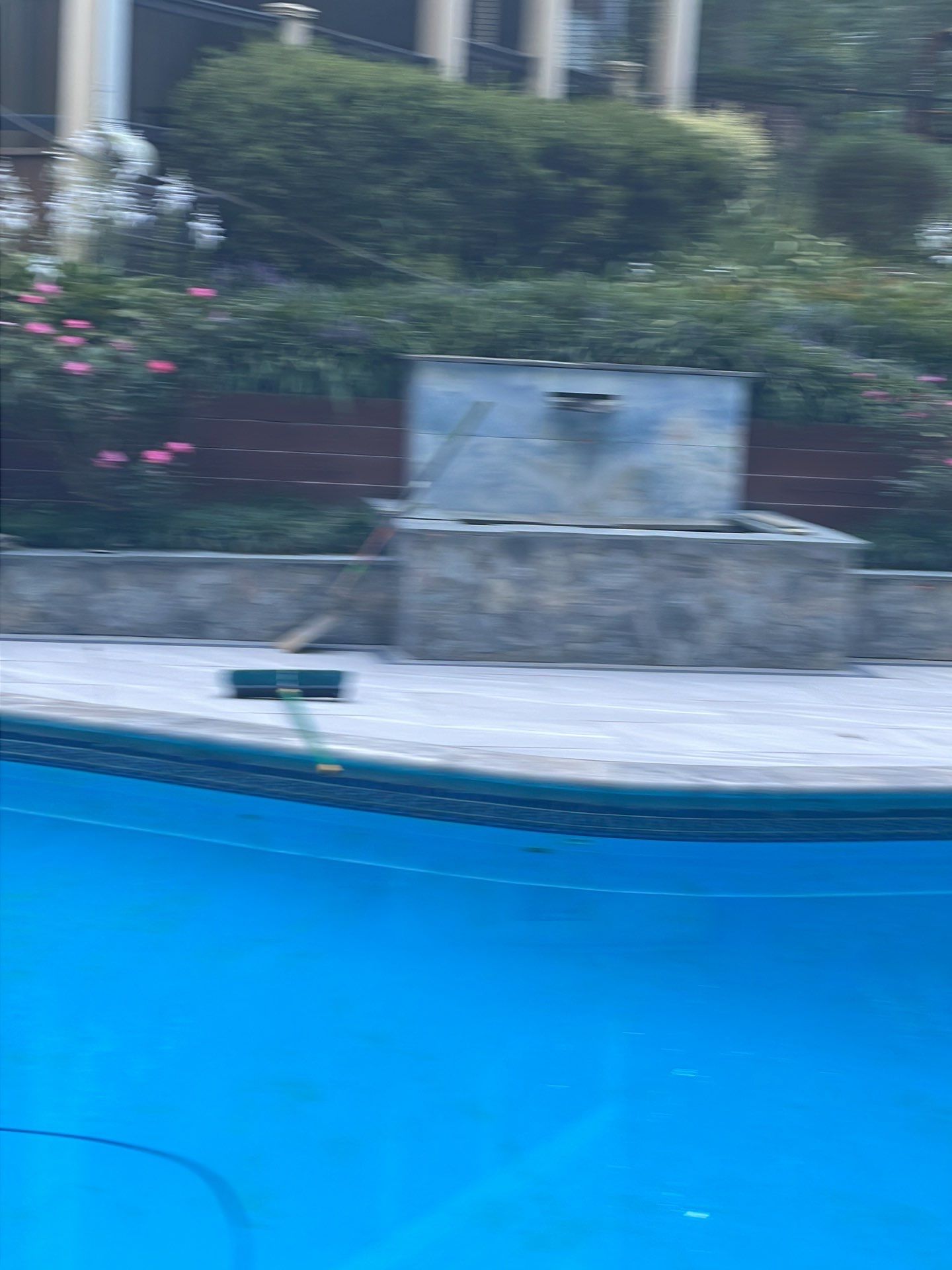 Pool Surround remodel with retaining walls, new waterfall and water slide by Fairfax Contractors, LLC