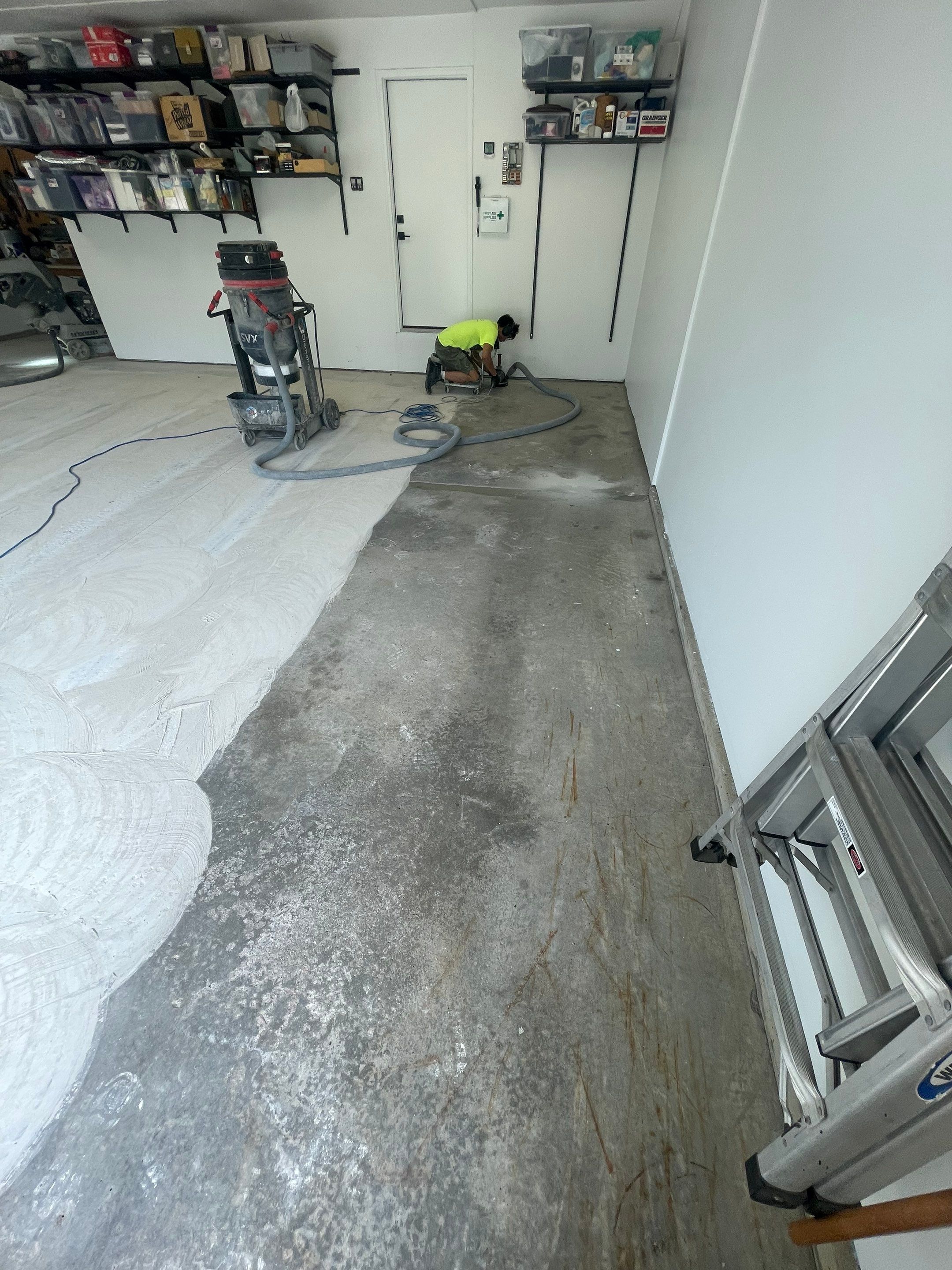 Feather Grey Garage Floor Coating Installation in Sioux Falls by Select Painting, Coatings & Garage Cabinets