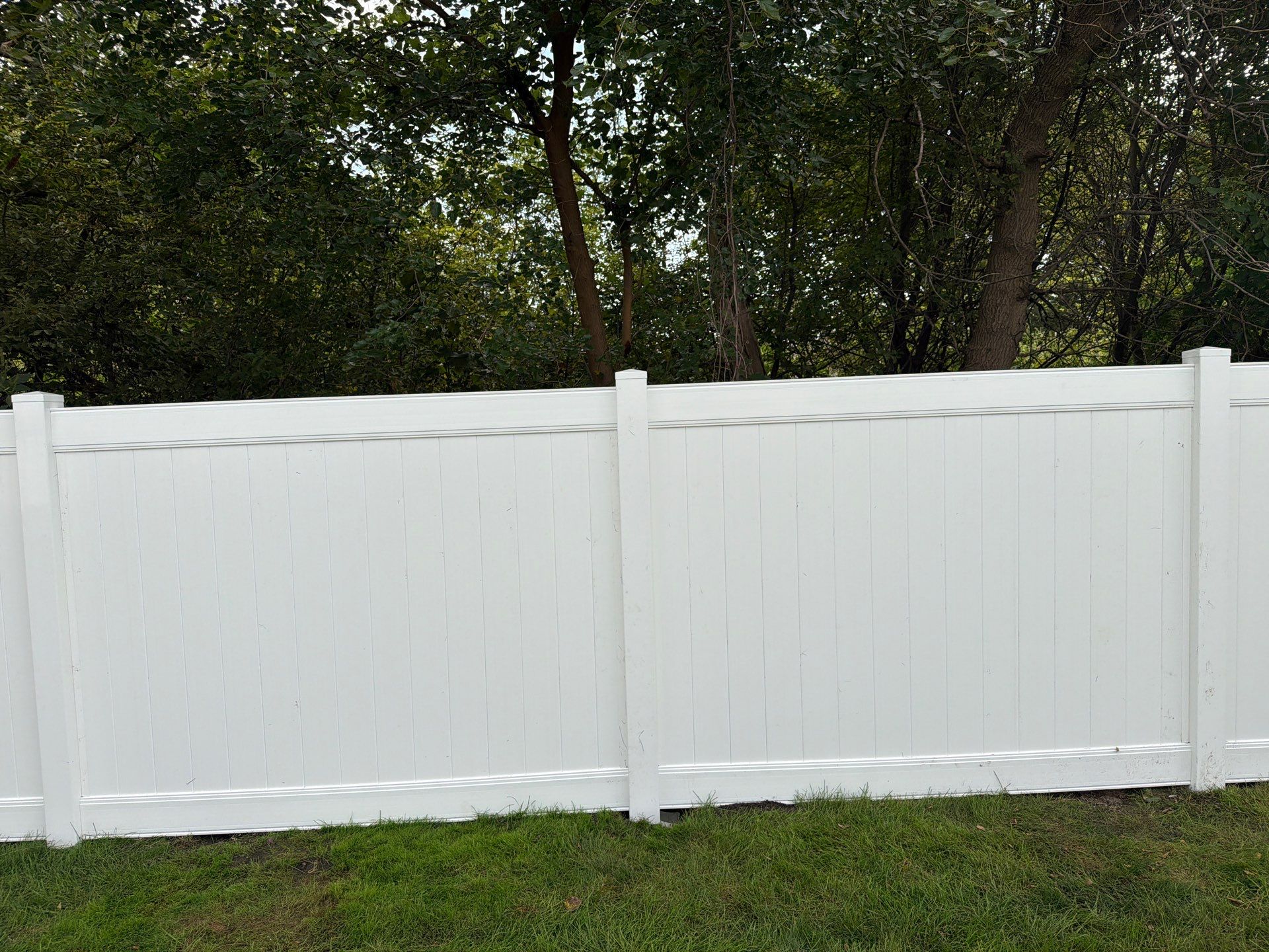 White Vinyl Privacy Fence Installation in Raymond, IA by Perfect Picket Fence and Stain
