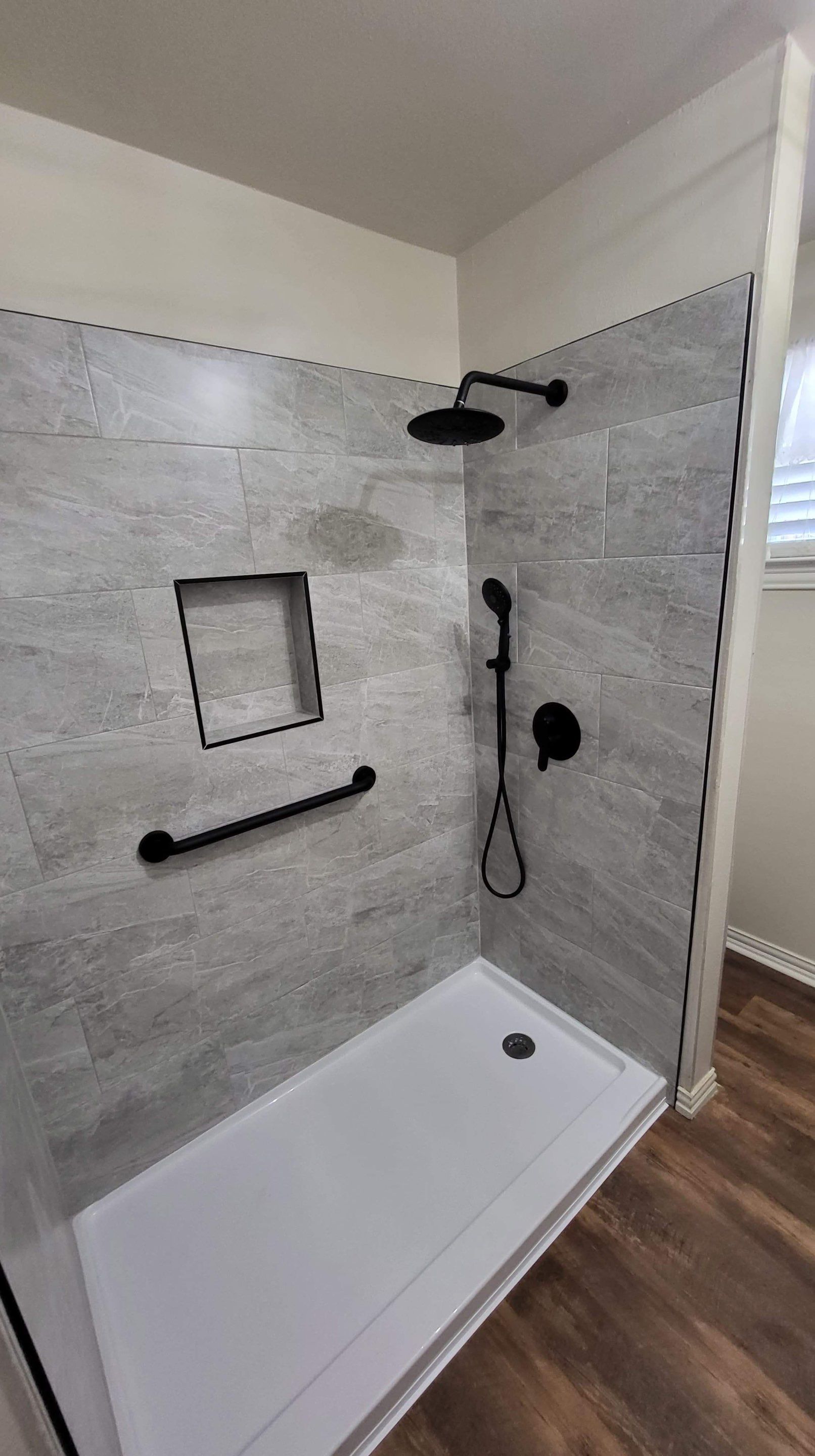 Bathroom Remodel using Tile  by SLM General Contractors & Roofing