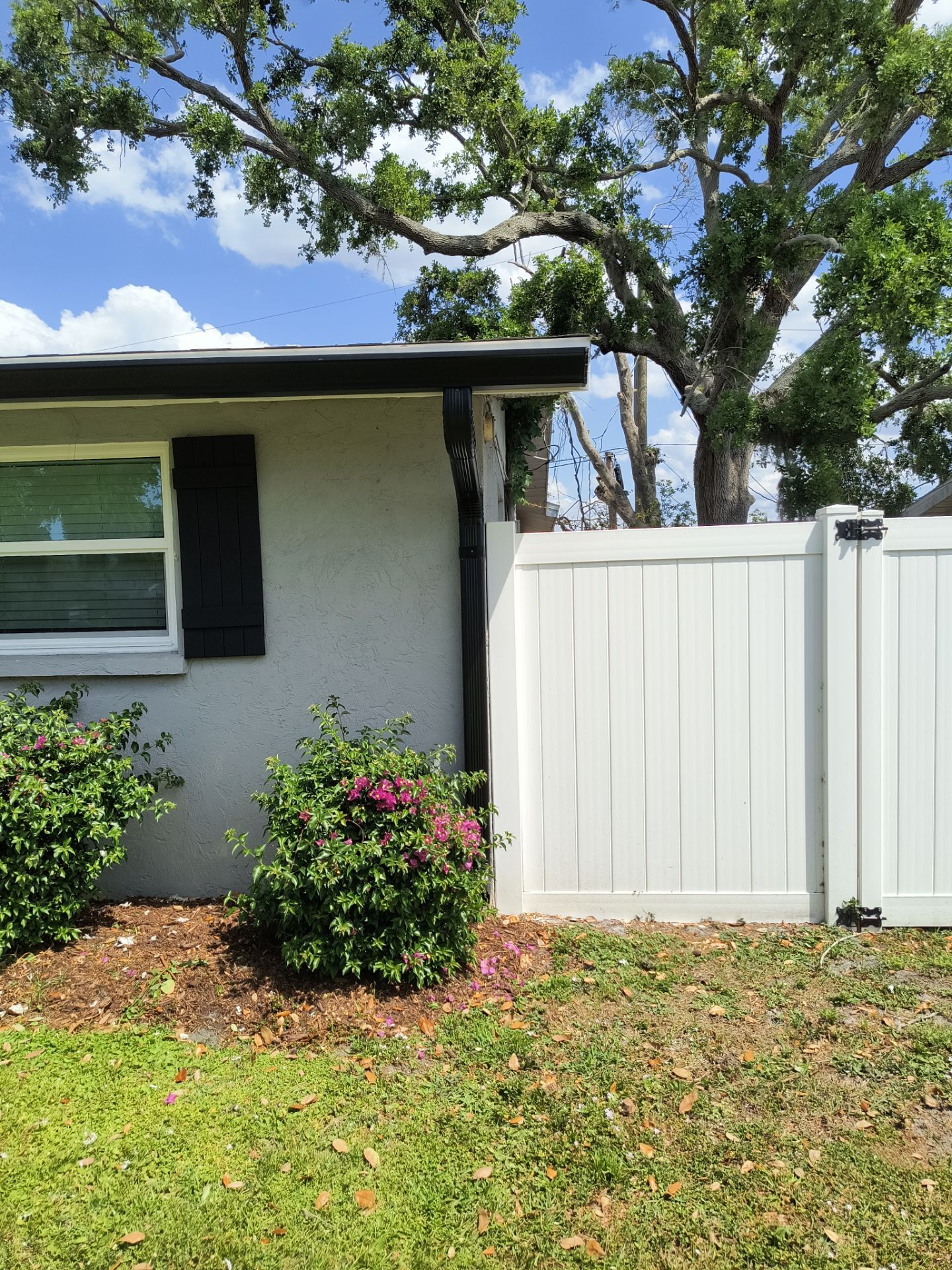Black Seamless Gutters using 7 inch seamless gutters & New White Soffit in Sarasota FL by Gutter Professors