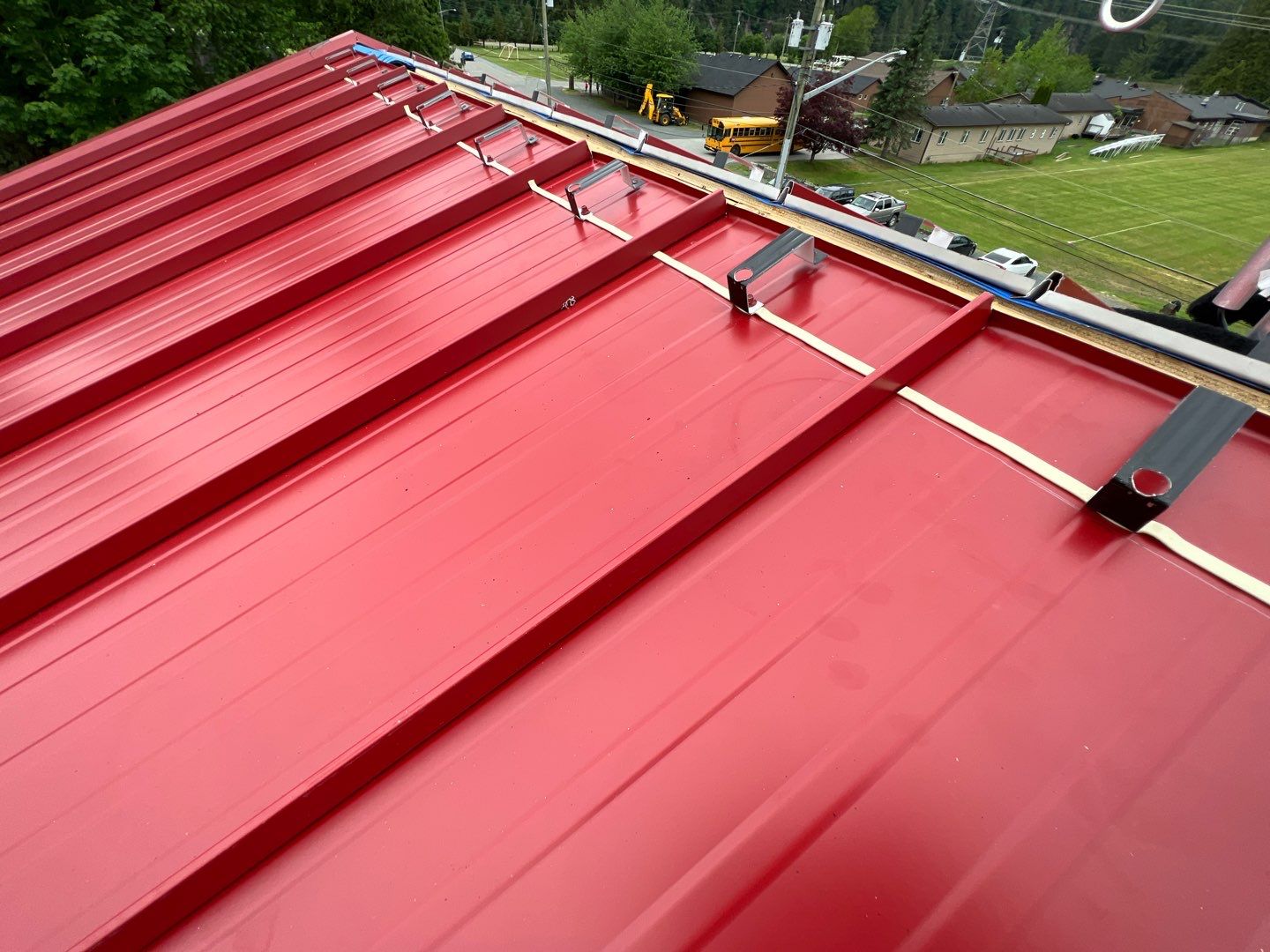 Commercial Roofing Installation using 12" Prolok metal  by Top Notch Roofing Inc