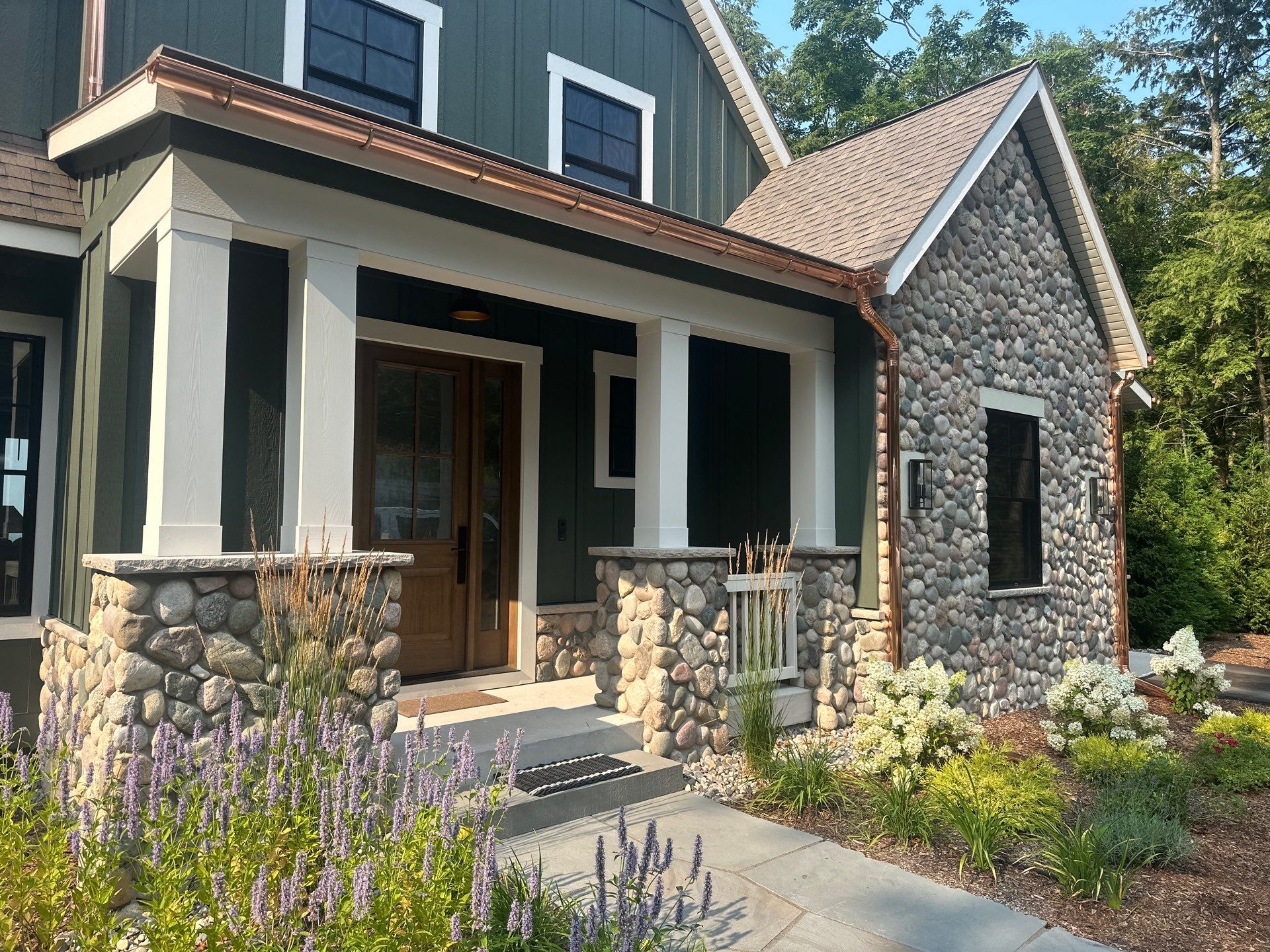 Copper Gutter and Downspout Installation for Omena Residence by Rainbow Seamless Systems