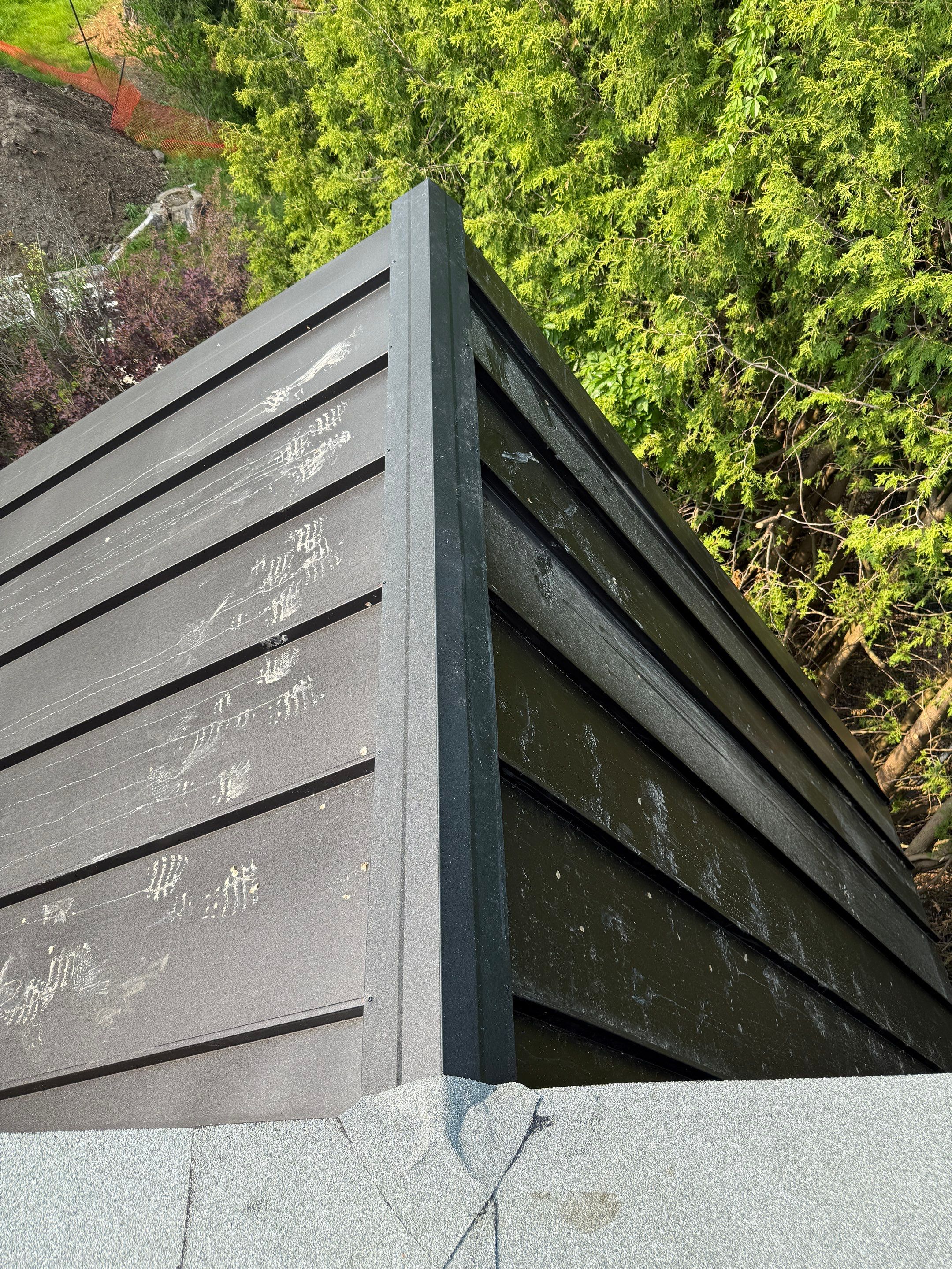 Custom Home Jet Black 24 GA Standing Seam Roof  by Jay Carter Roofing & Sheet Metal