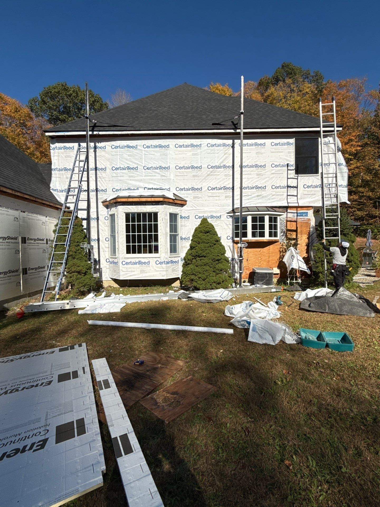 Bold Siding transformation with Cert Cedar Board & Batten S12, White, and Cert Monogram D/4 x 12'6" clapboard, Tuxedo by DiGiorgi Roofing and Siding Inc