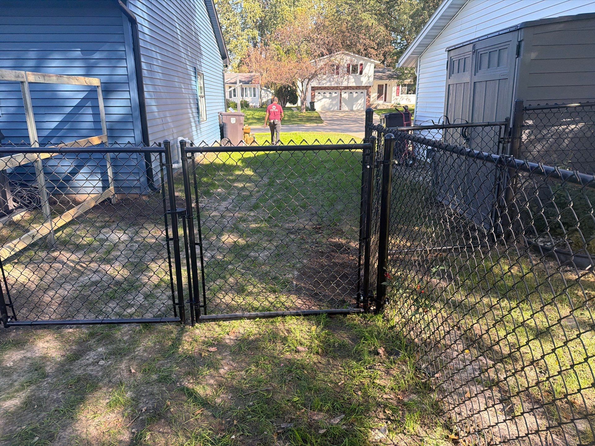 Black Chain Link Fence Installation with Double Gate in Cedar Falls by Perfect Picket Fence and Stain