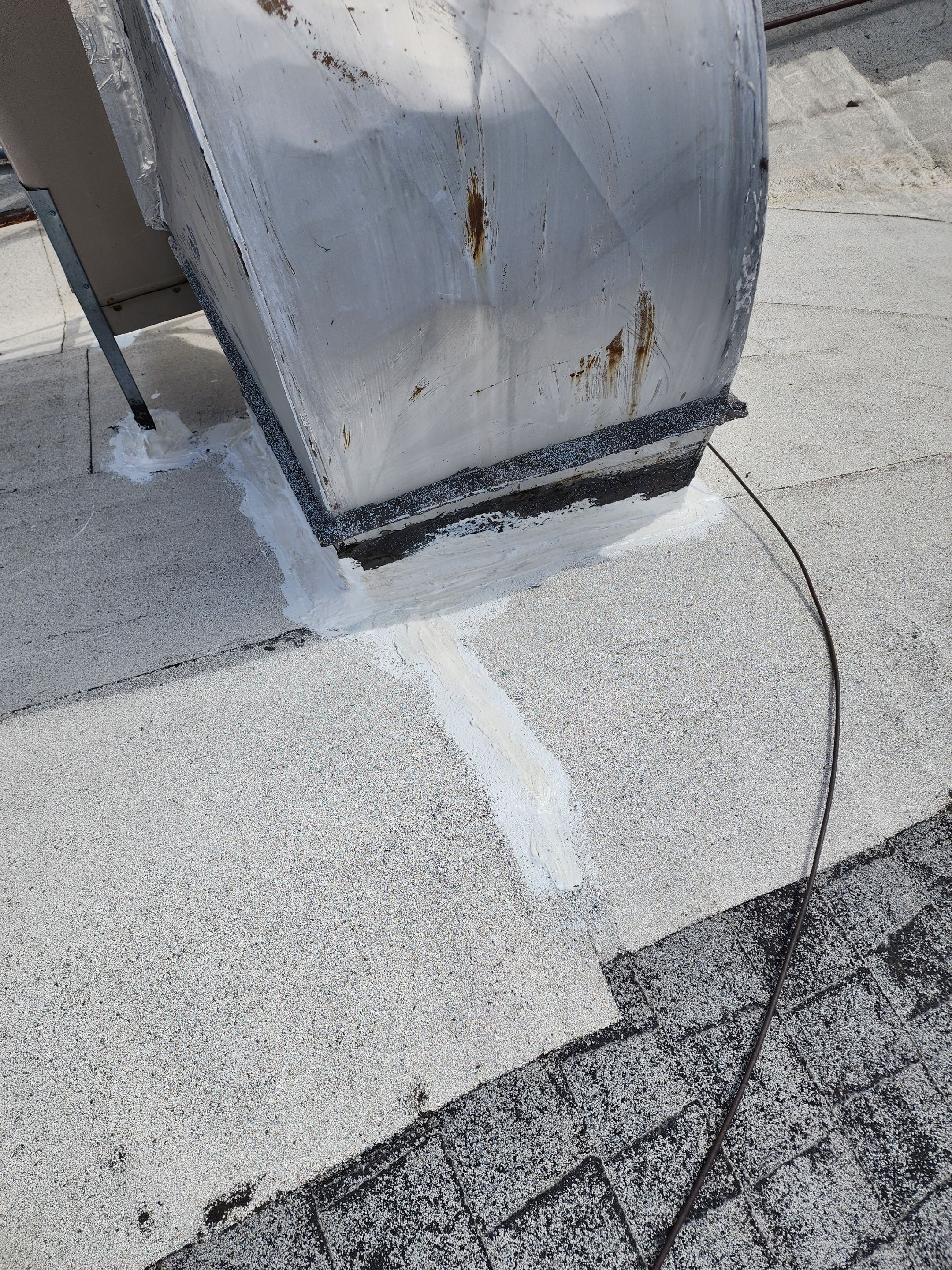 Foam and coatings on commercial roof by Straight Edge Roofing Inc