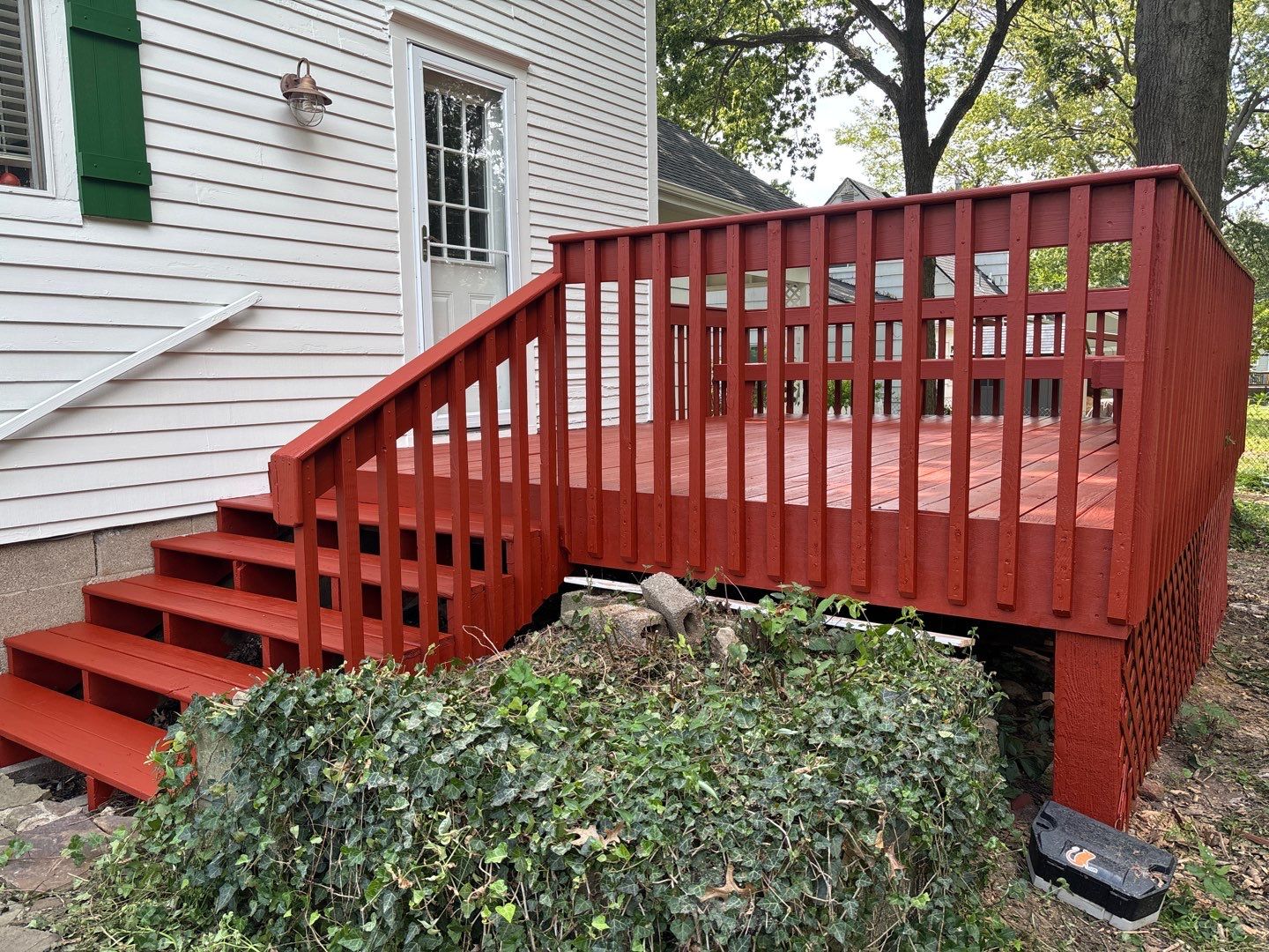 This 100-year-old home shines with a fresh coat of Spare White, bold Arugula accents on the front door and shutters, and a warm Fired Brick deck for timeless curb appeal. by Cougar Painting