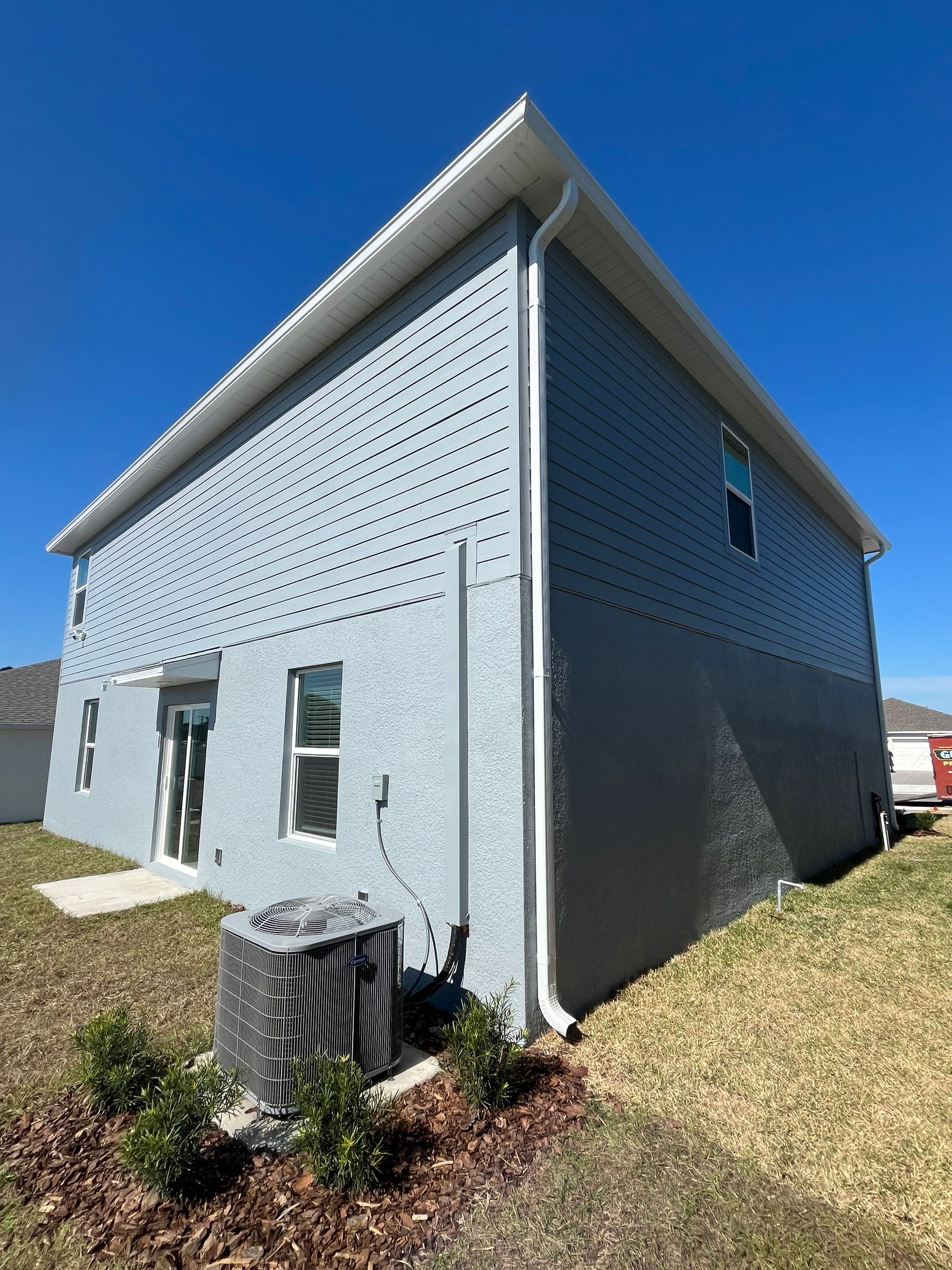 White Down Spouts and Seamless Gutters using downspouts in Dade City FL by Gutter Professors