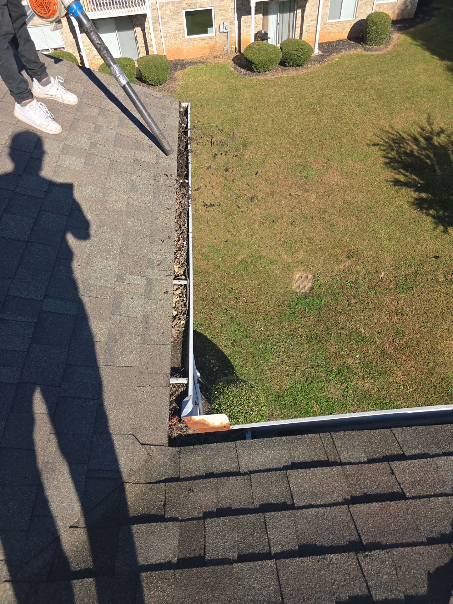Commercial gutter cleaning Gastonia, NC before photo with filled gutters