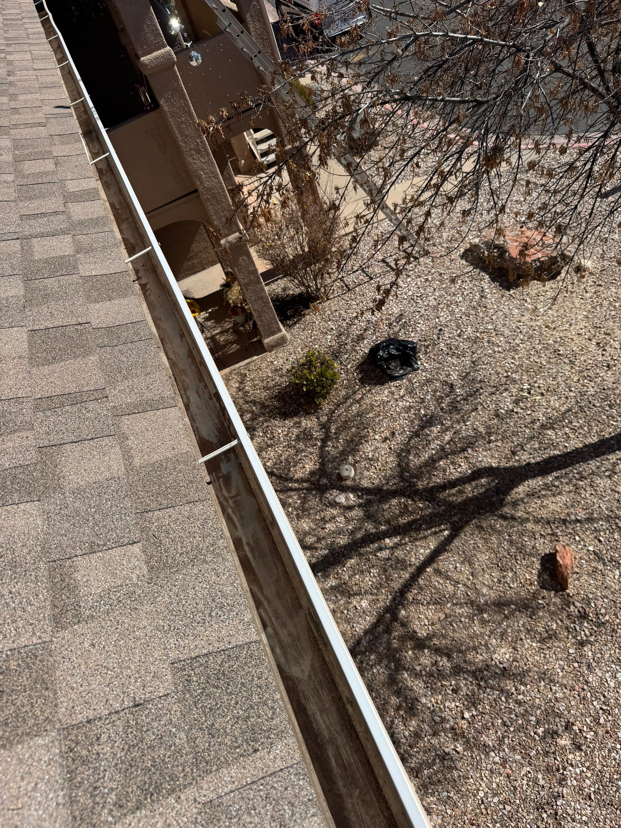 HOA gutter cleaning in Mesquite, NV, after  photo showing full gutters.