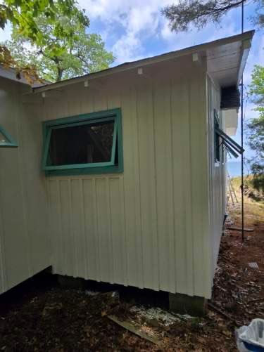 Lakeside Cottage Exterior Painting and Teal Trim Restoration in Mears by Gordon Painting