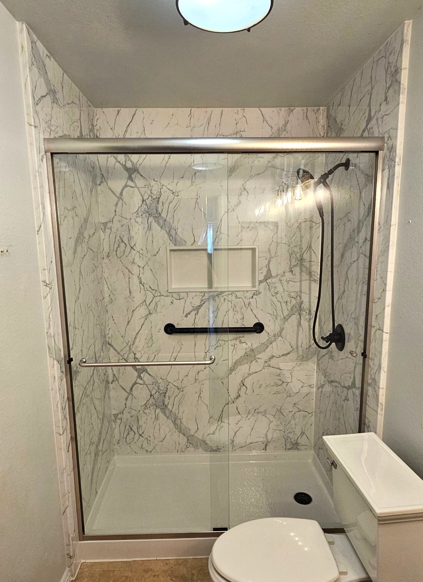 Accessible Shower Transformation with White Marble Panels in Winchester