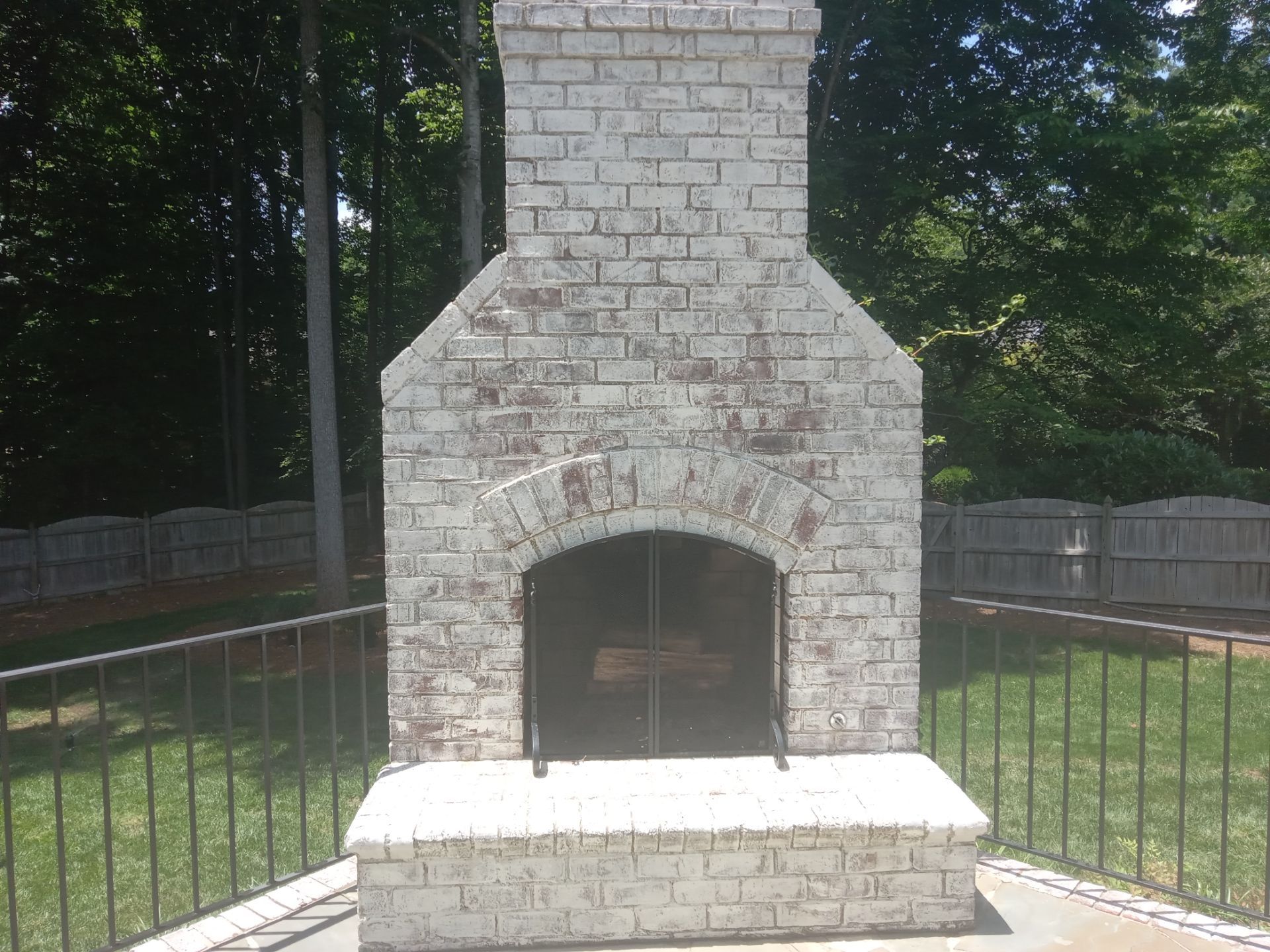 pressure washing outdoor brick fireplace patio to remove dirt grime restore appearance