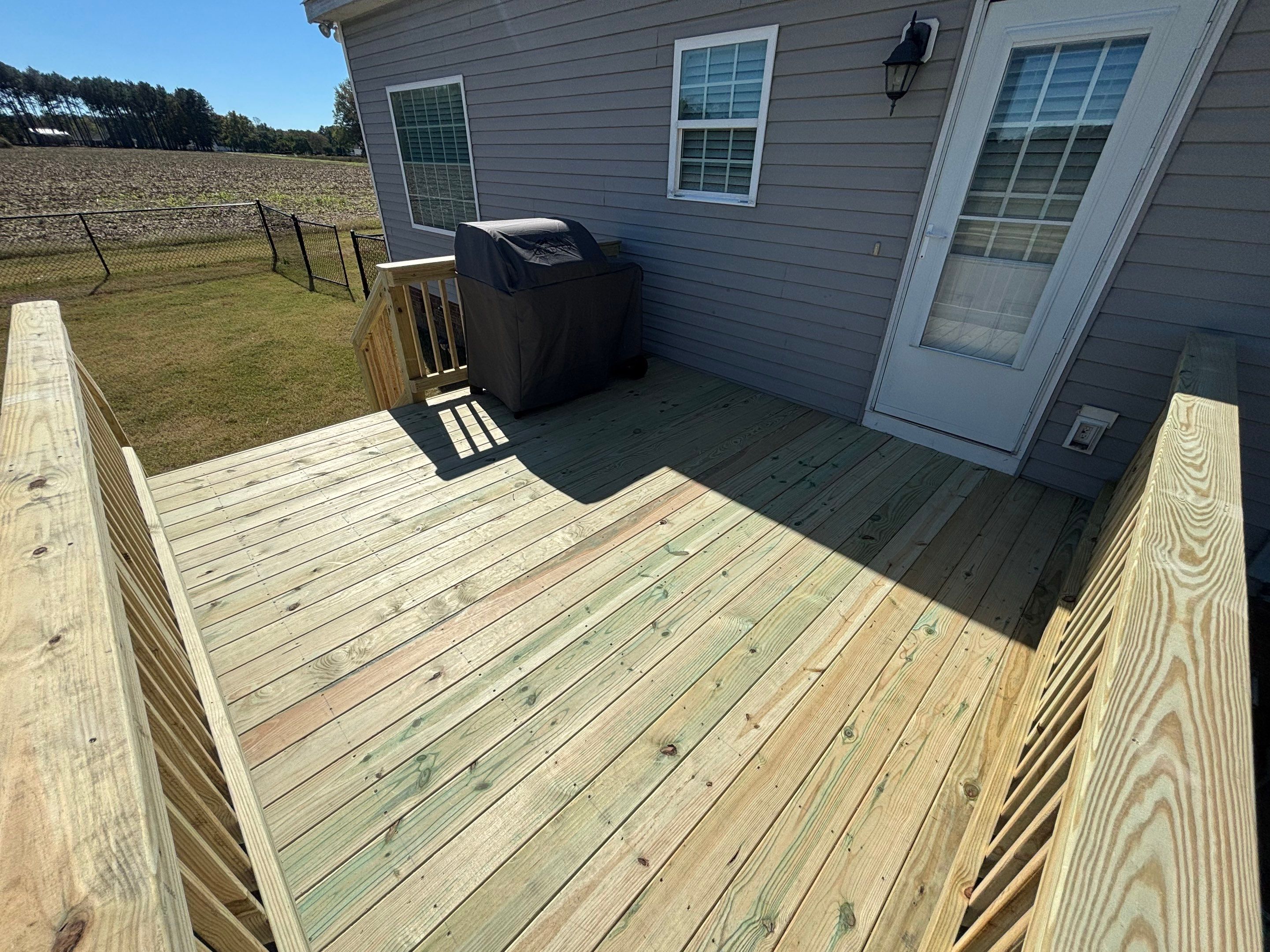 Pressure-Treated Wood Deck Resurface and Railing Replacement in Battleboro by The Remodeling Company