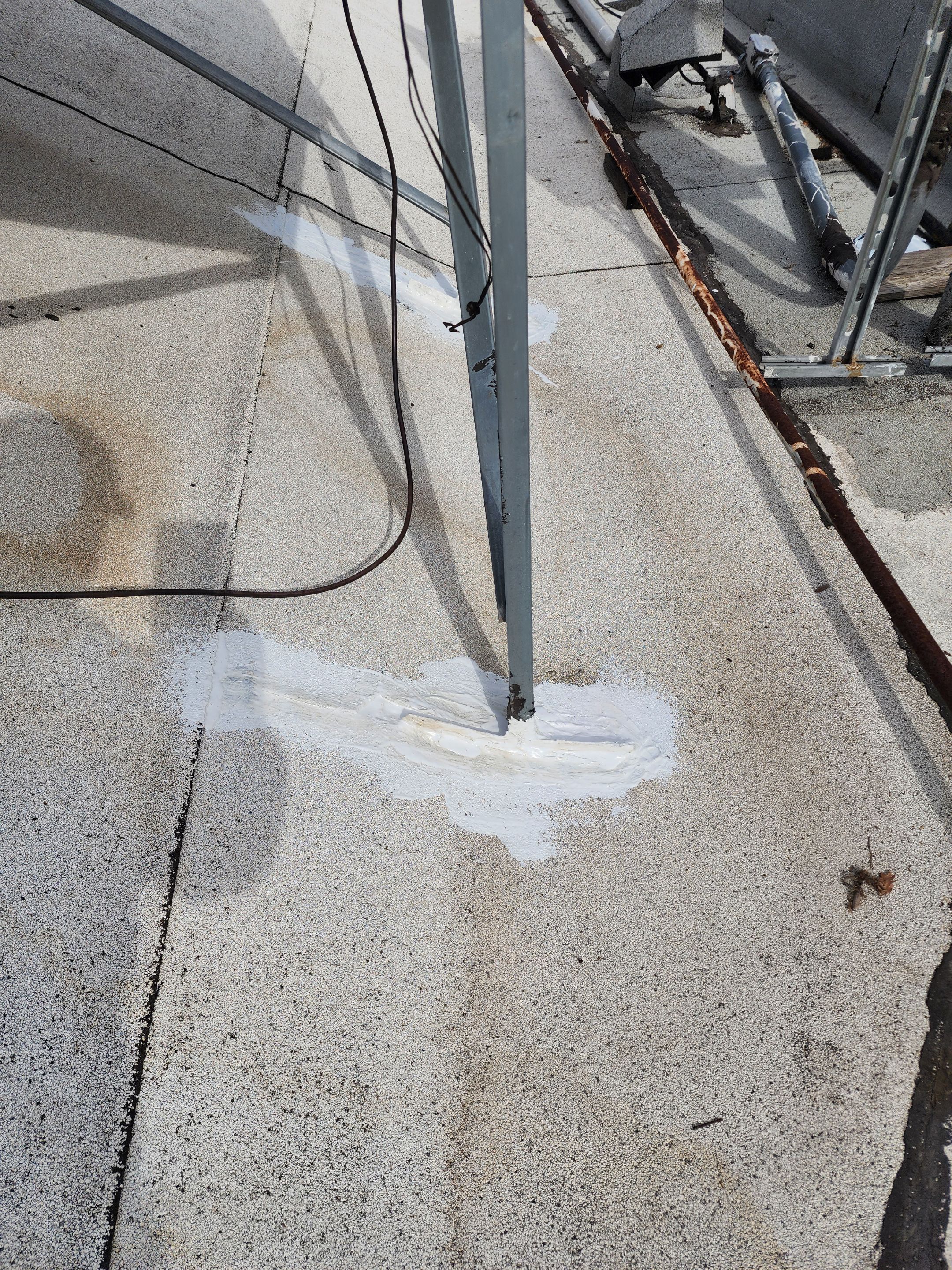 Foam and coatings on commercial roof by Straight Edge Roofing Inc