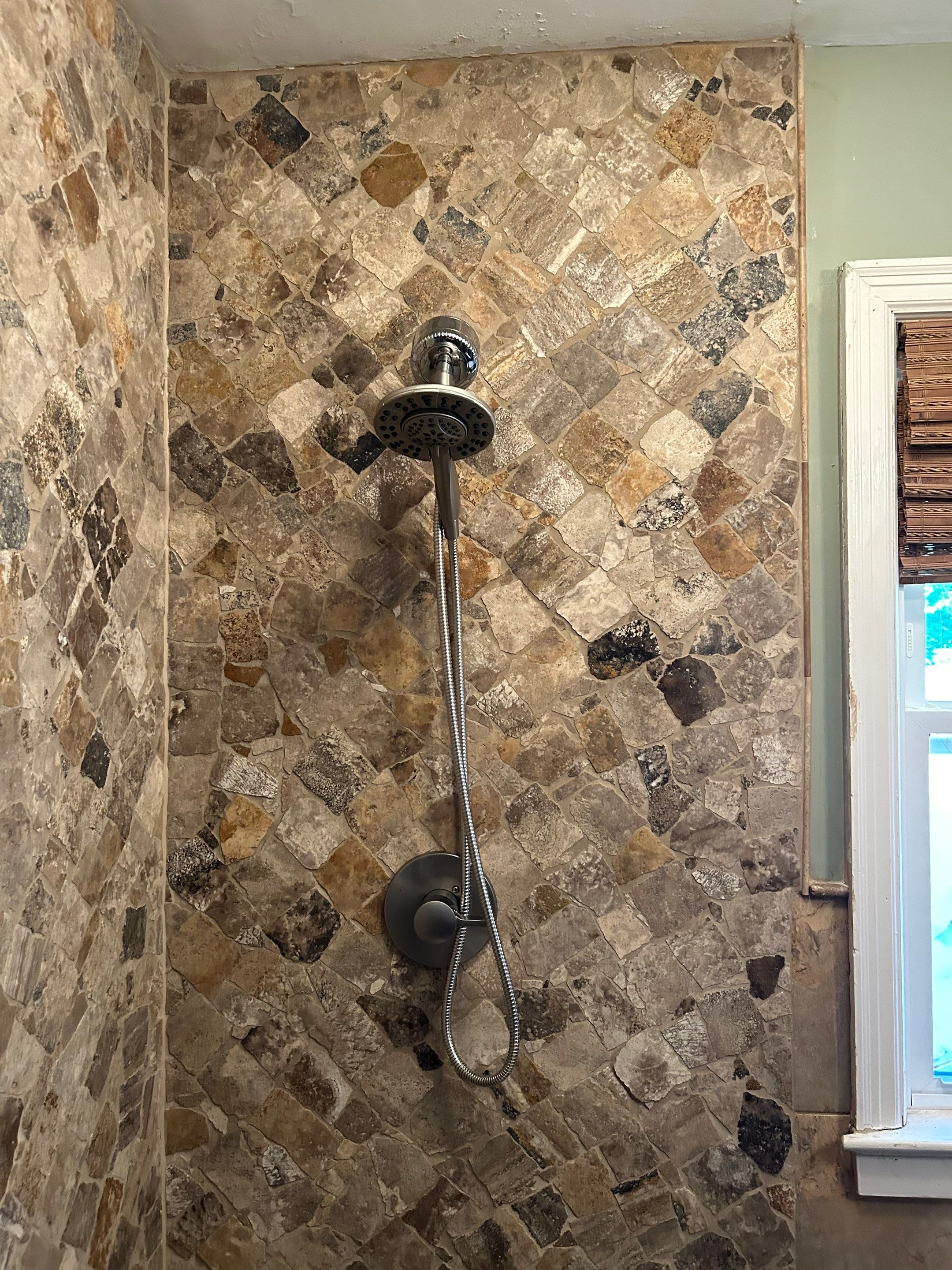 Natural Stone Shower Remodel and Pebble Floor Installation in Louisville by Footprints Floors Kentucky