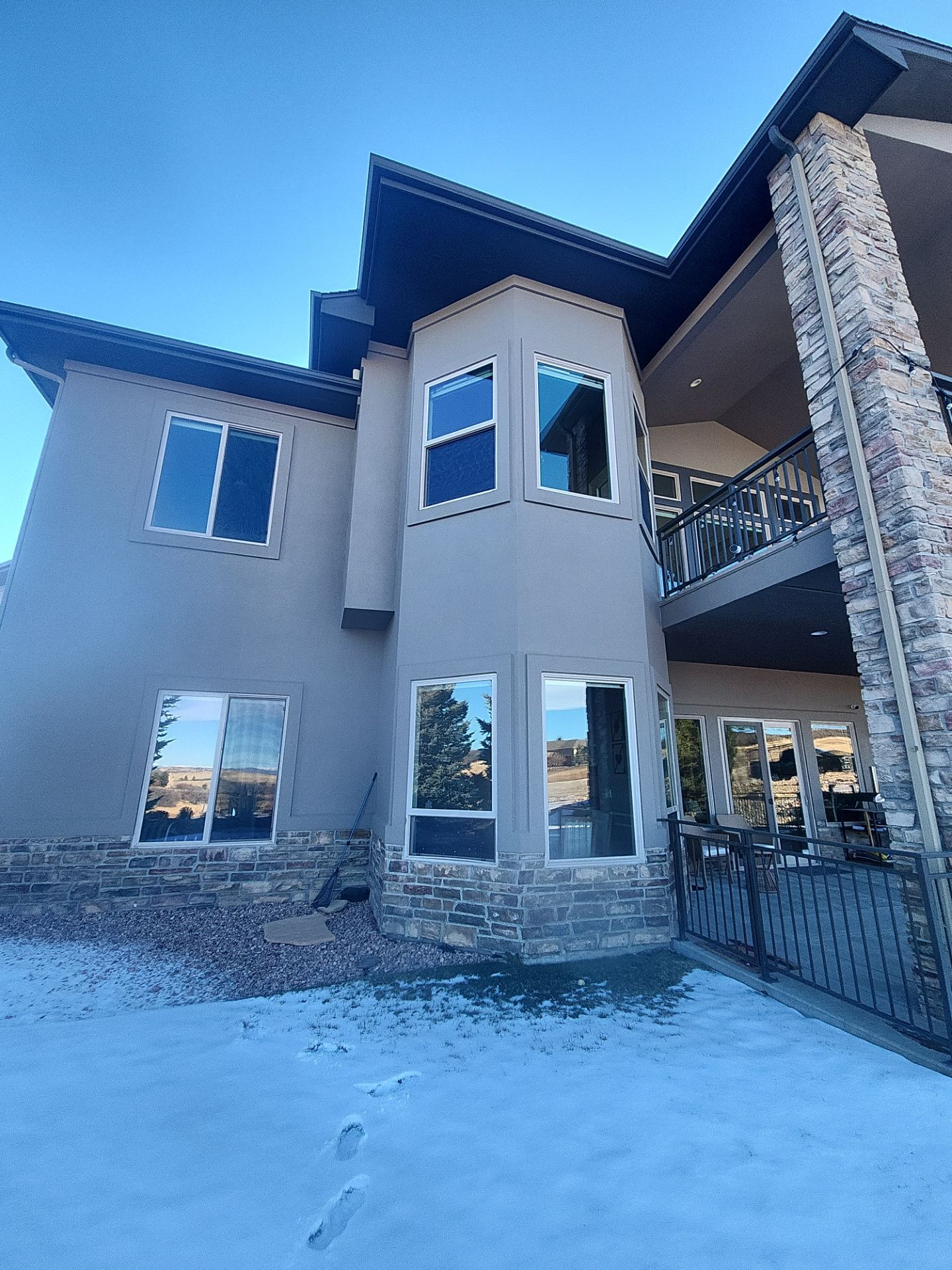 Castle Rock Elegance: White Stucco Exterior with Bold Tricorn Black by J&M Painting LLC