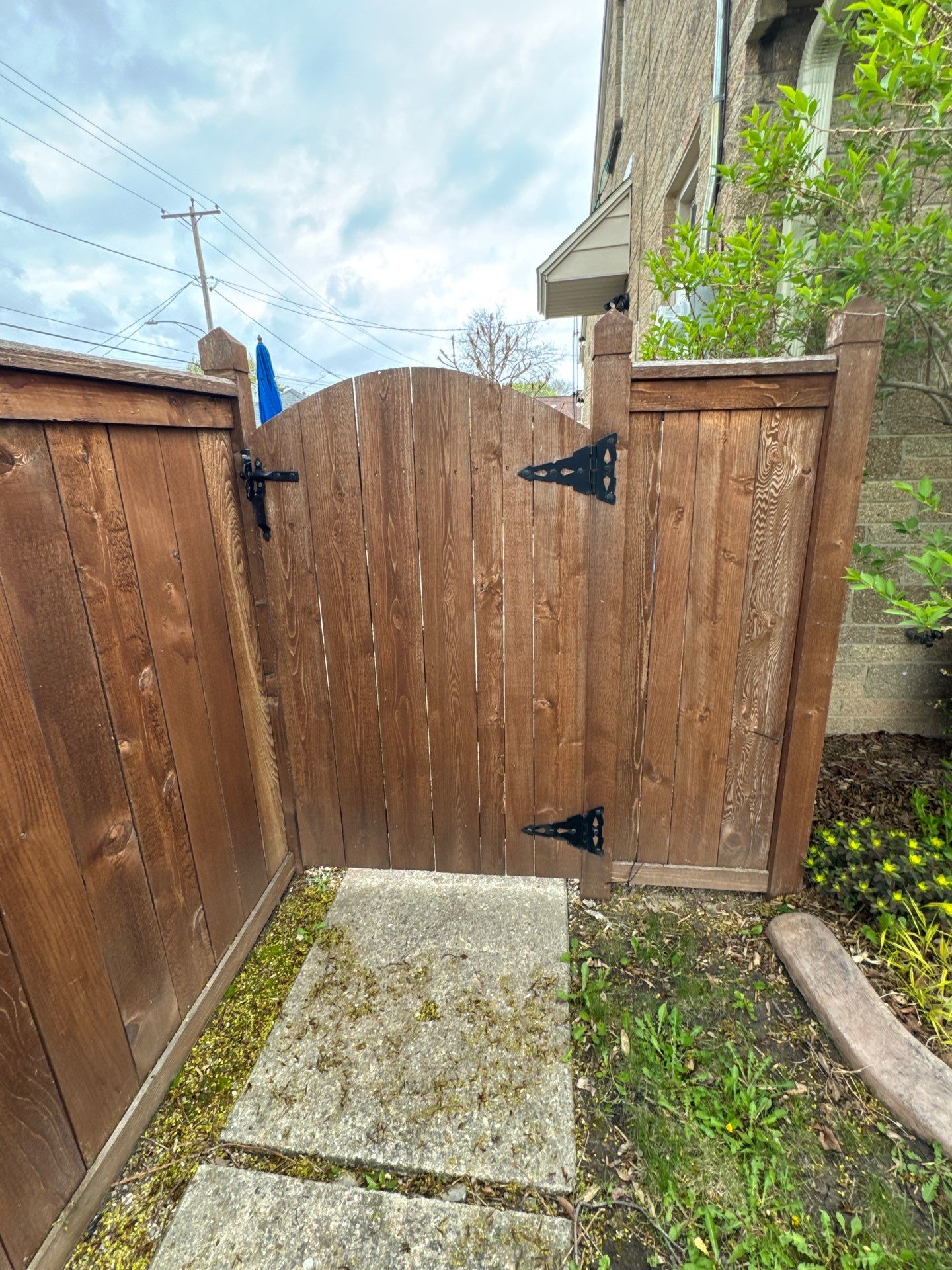 Dark Stained Privacy Fence and Composite Deck in Milwaukee by OCS Contracting Services